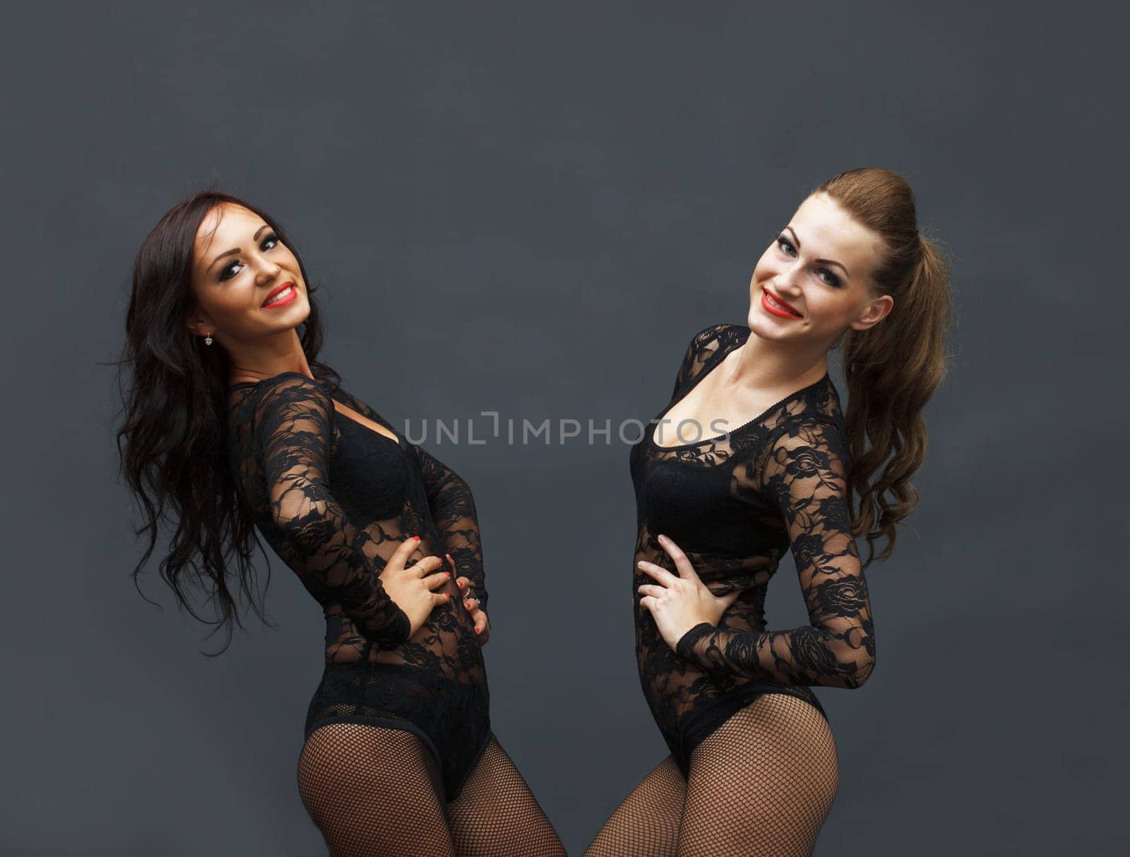 Funny young women posing in identical costumes, close-up