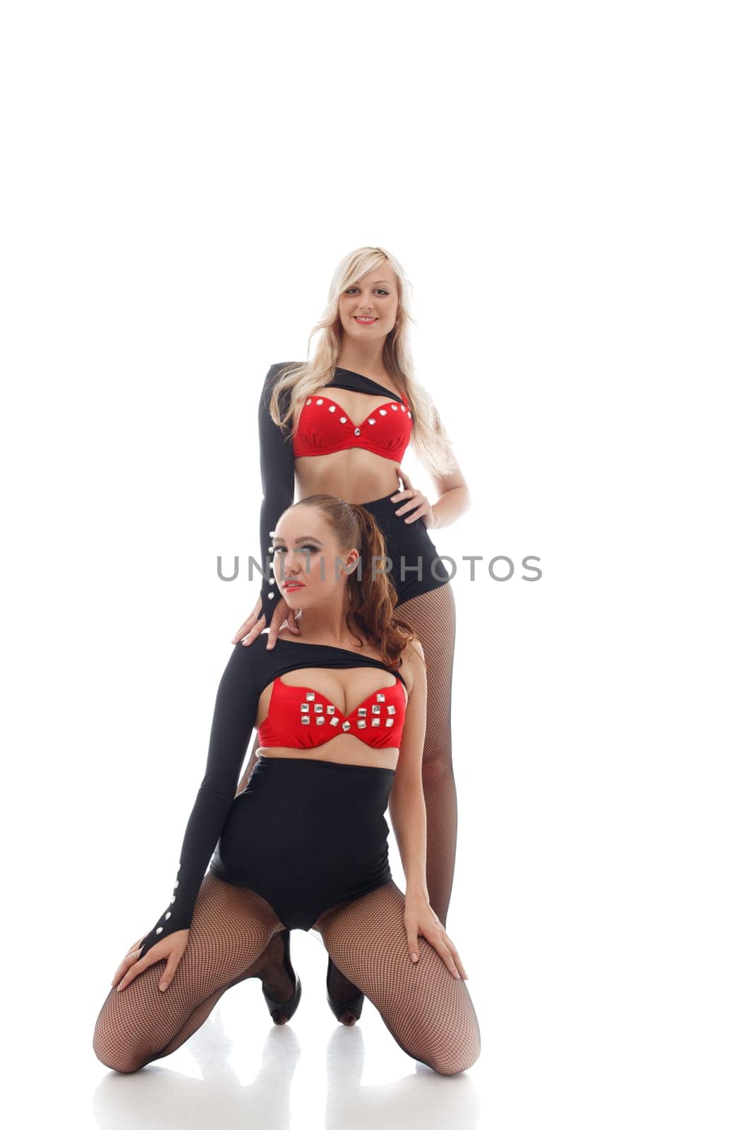 Smiling attractive go-go dancers isolated on white background