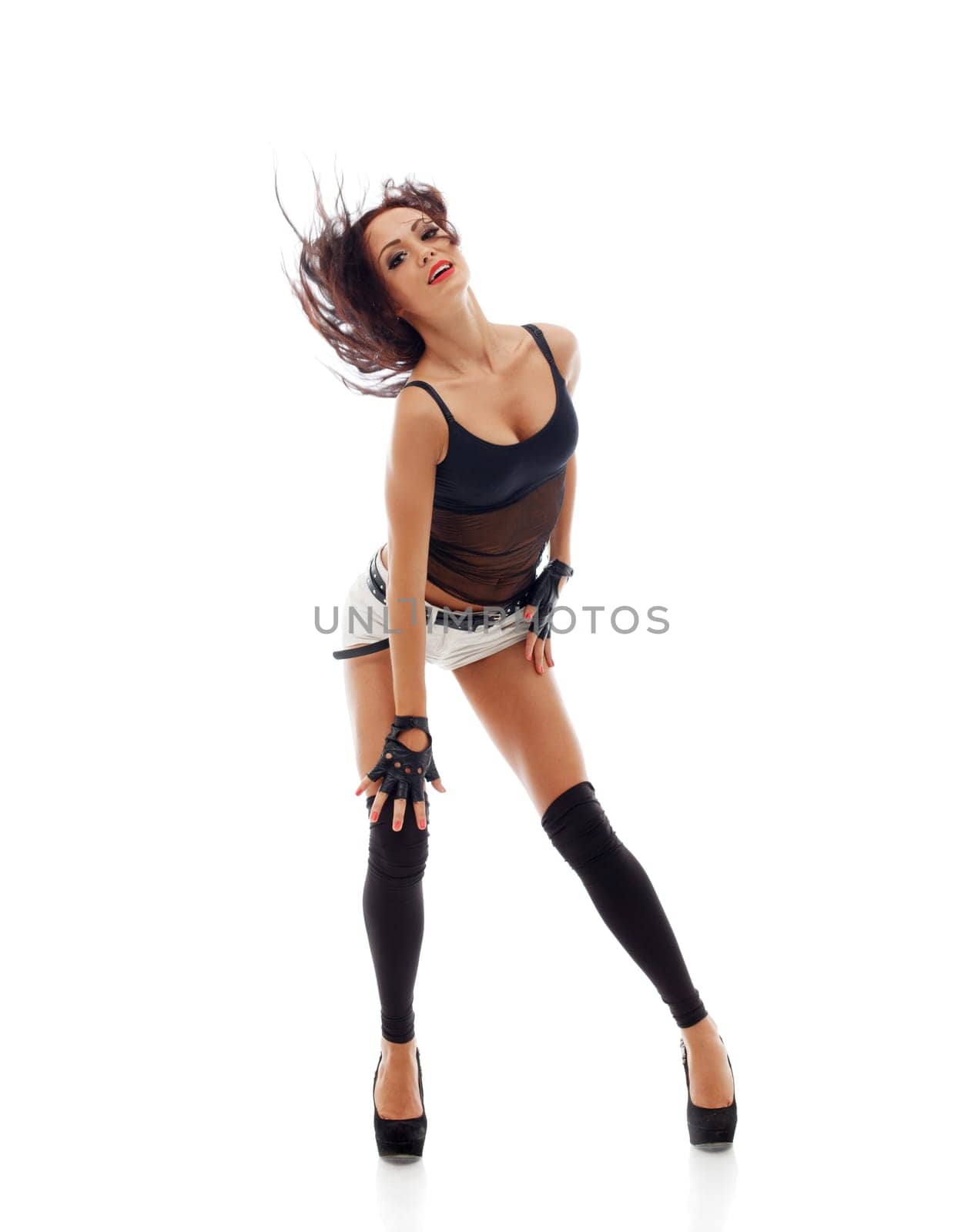 Emotional athletic woman dancing in studio, isolated on white