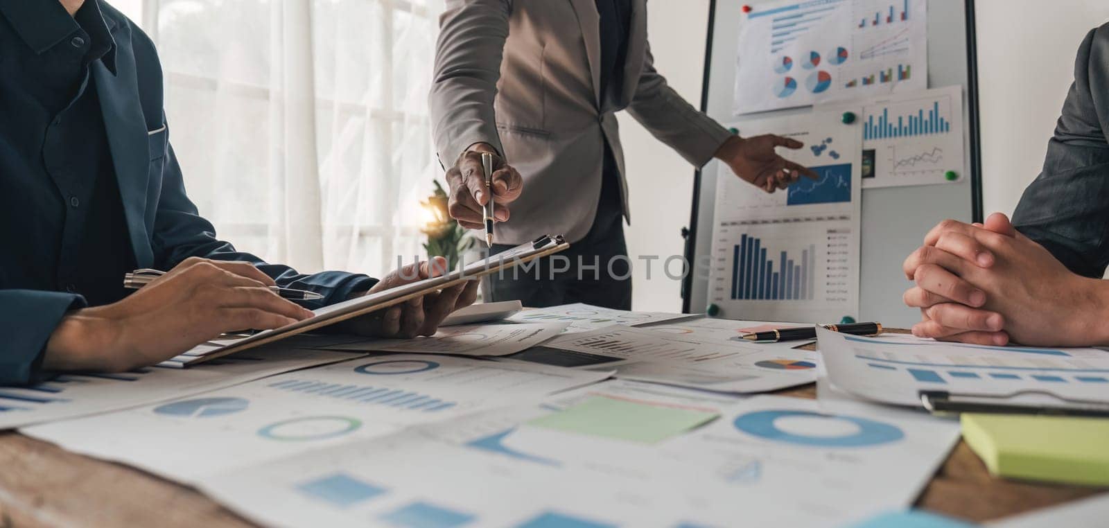 Business People Meeting using laptop computer,calculator,notebook,stock market chart paper for analysis Plans to improve quality next month. Conference Discussion Corporate Concept.. by wichayada