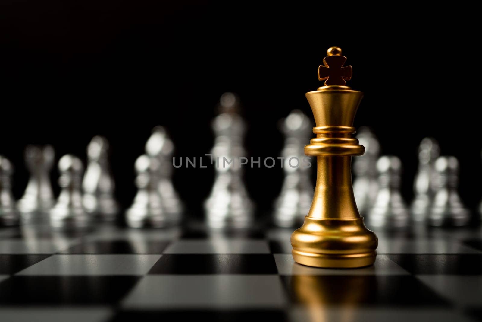 Golden King chess standing in front of other chess, Concept of a leader must have courage and challenge in the competition, leadership and business vision for a win in business games