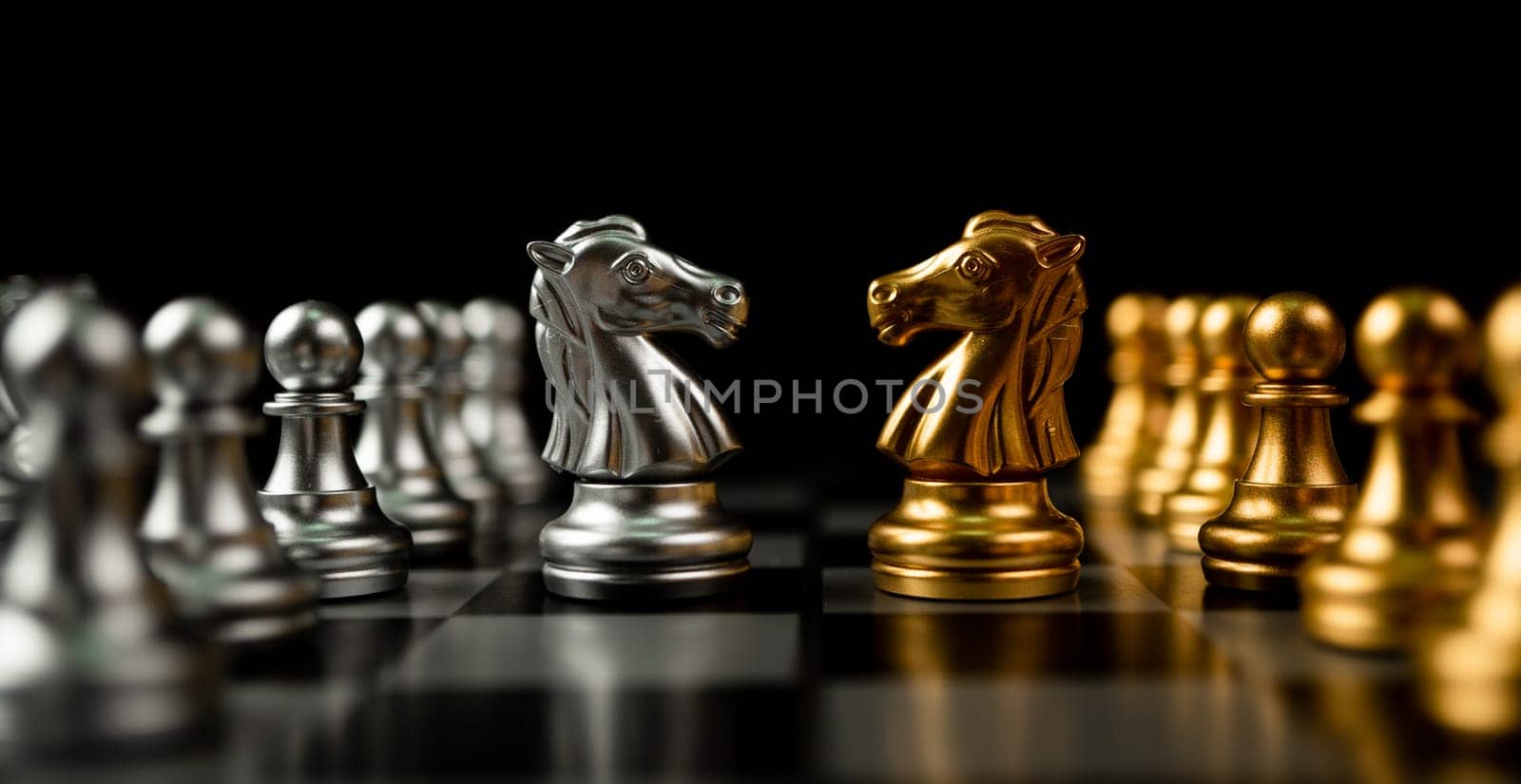 Golden and silver horse chess pieces Invite face to face and There are chess pieces in the background. Concept of competing, leadership and business vision for a win in business games by PattyPhoto