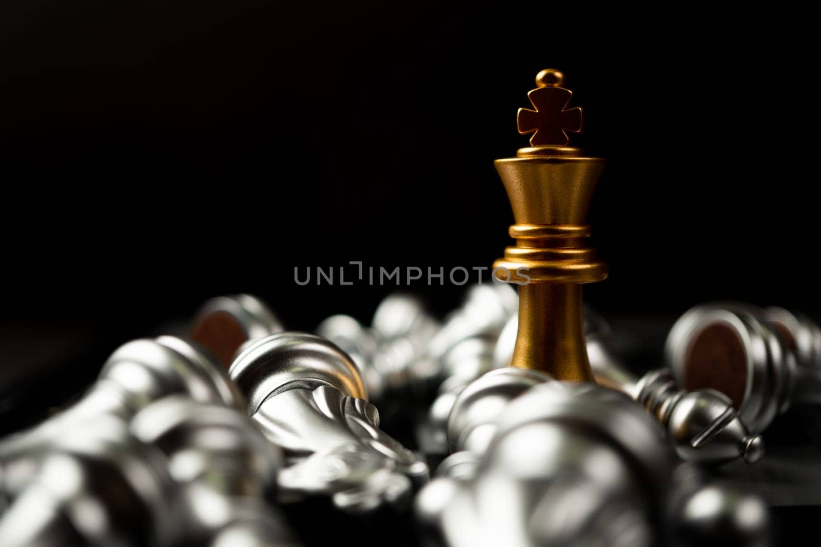 Golden King chess is last standing in the chess board, Concept of successful business leadership by PattyPhoto