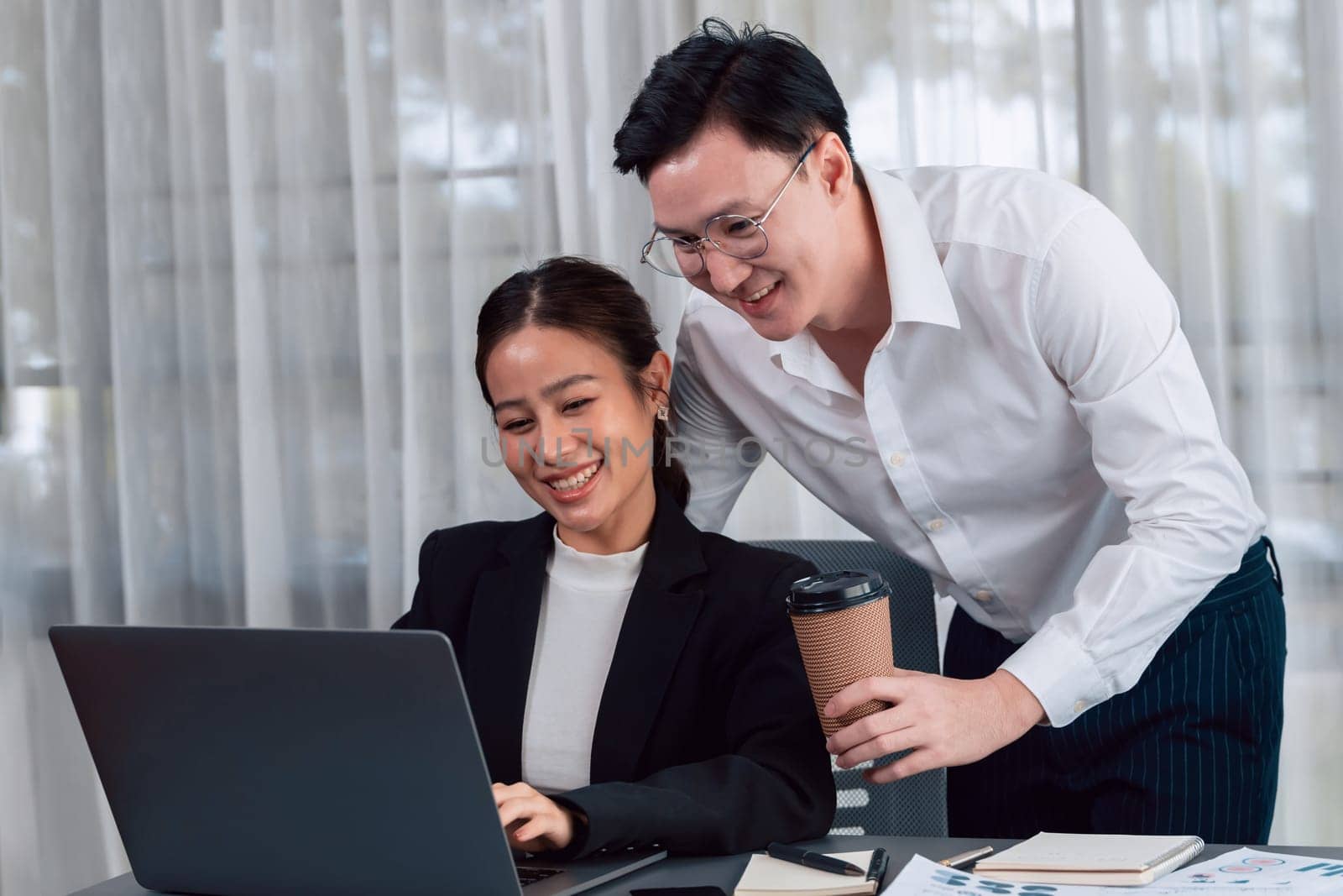 Mentor, manager with coffee advice younger colleagues in workplace. Couple businesspeople discussing financial strategy, working together for harmony and strong teamwork in office concept