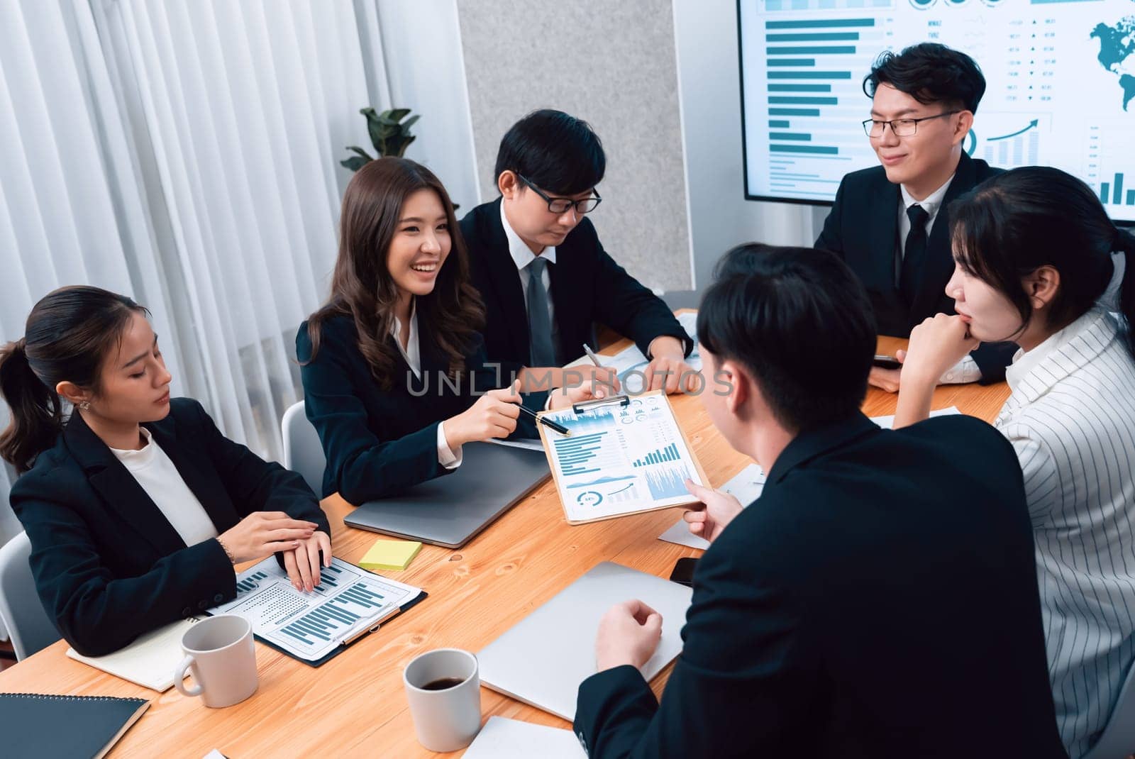 Business team of financial data analysis meeting with business intelligence, report paper and dashboard on laptop for marketing strategy. Business people working together to promote harmony in office.