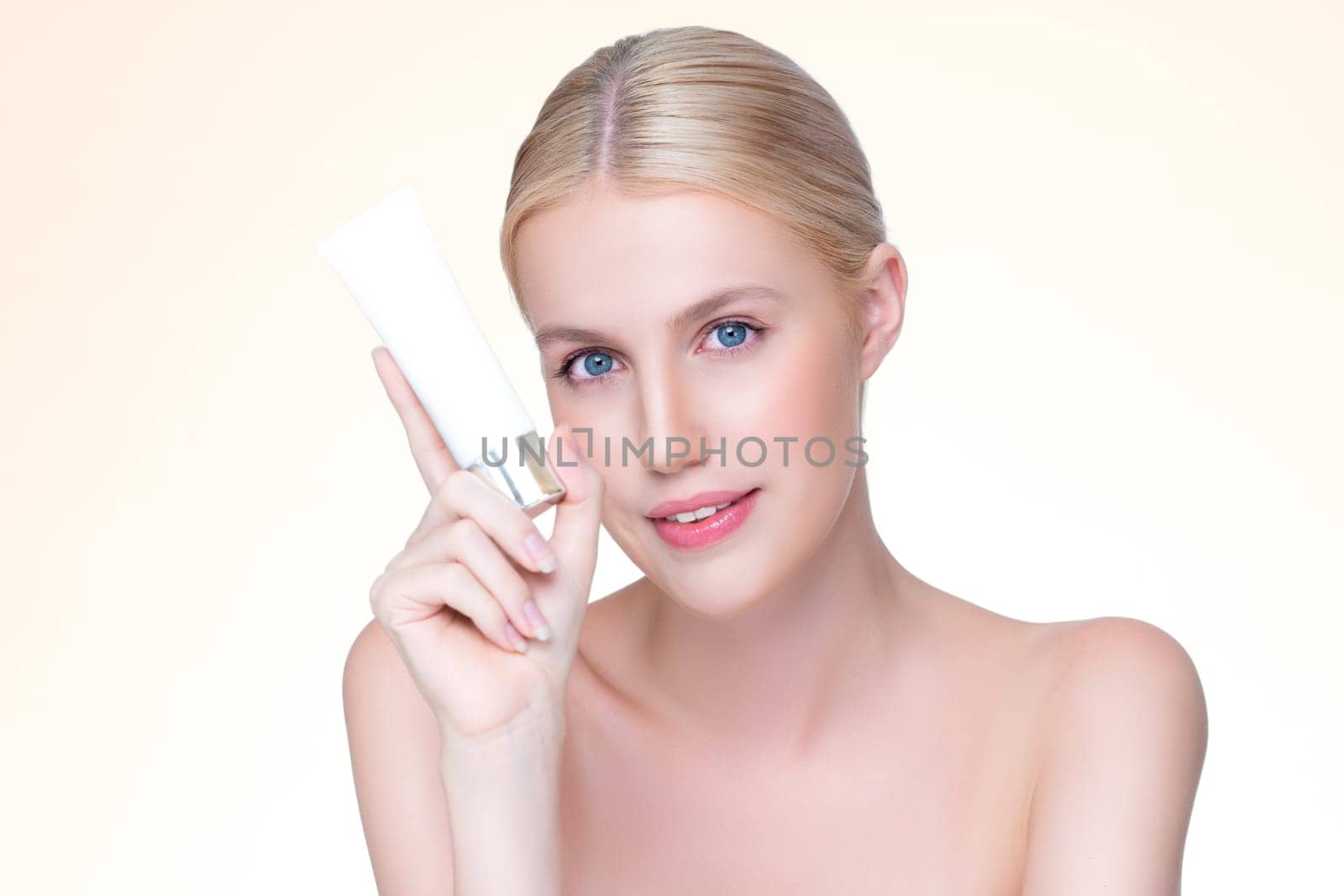 Personable beautiful perfect natural skin woman hold mockup tube moisturizer cream for skincare treatment product advertisement in isolated background with expressive facial and gesture expression.
