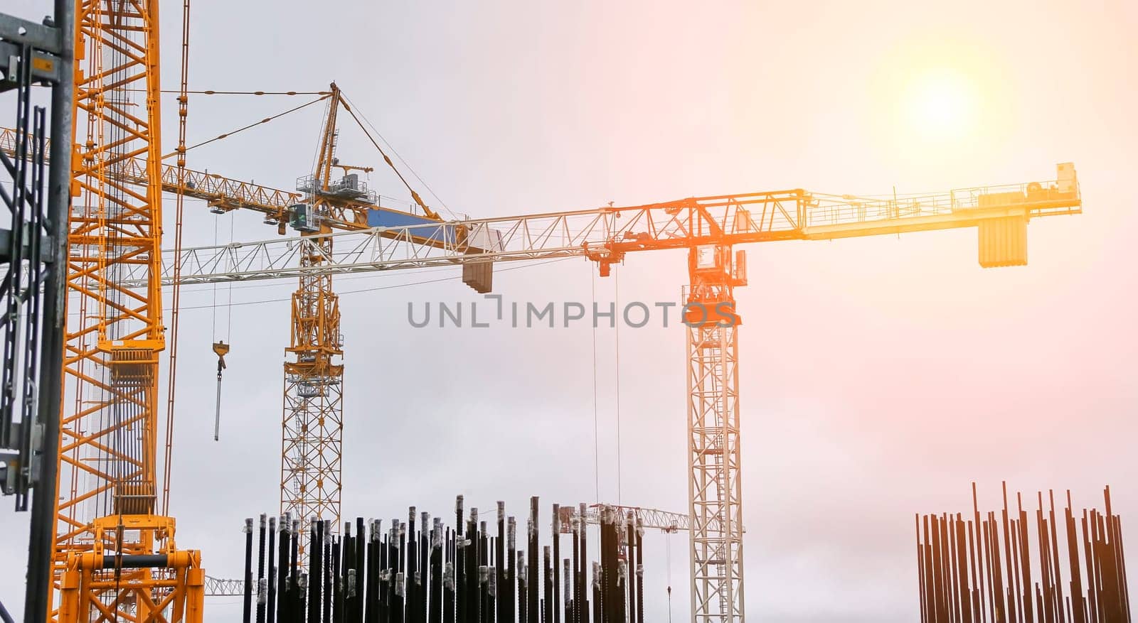 Construction of a nuclear power plant. Tower cranes on the background of the cooling tower.