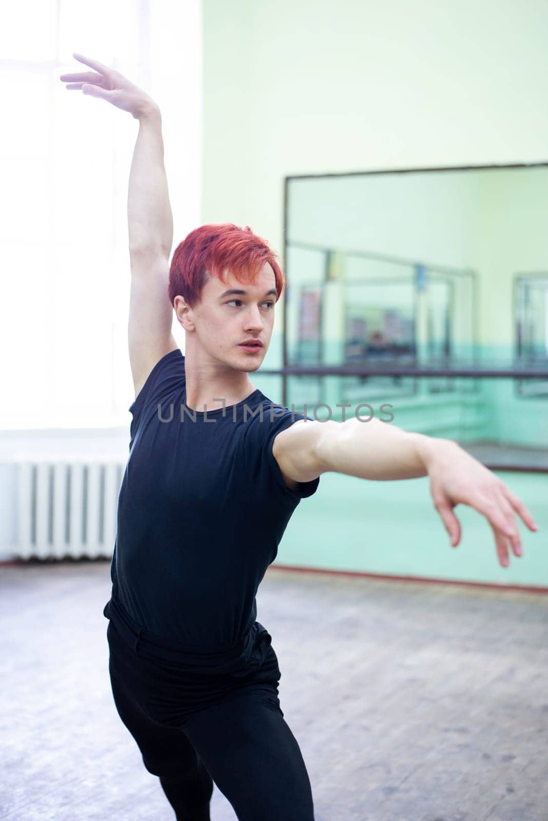 Elegant male dancer practicing new performance in dancing hall