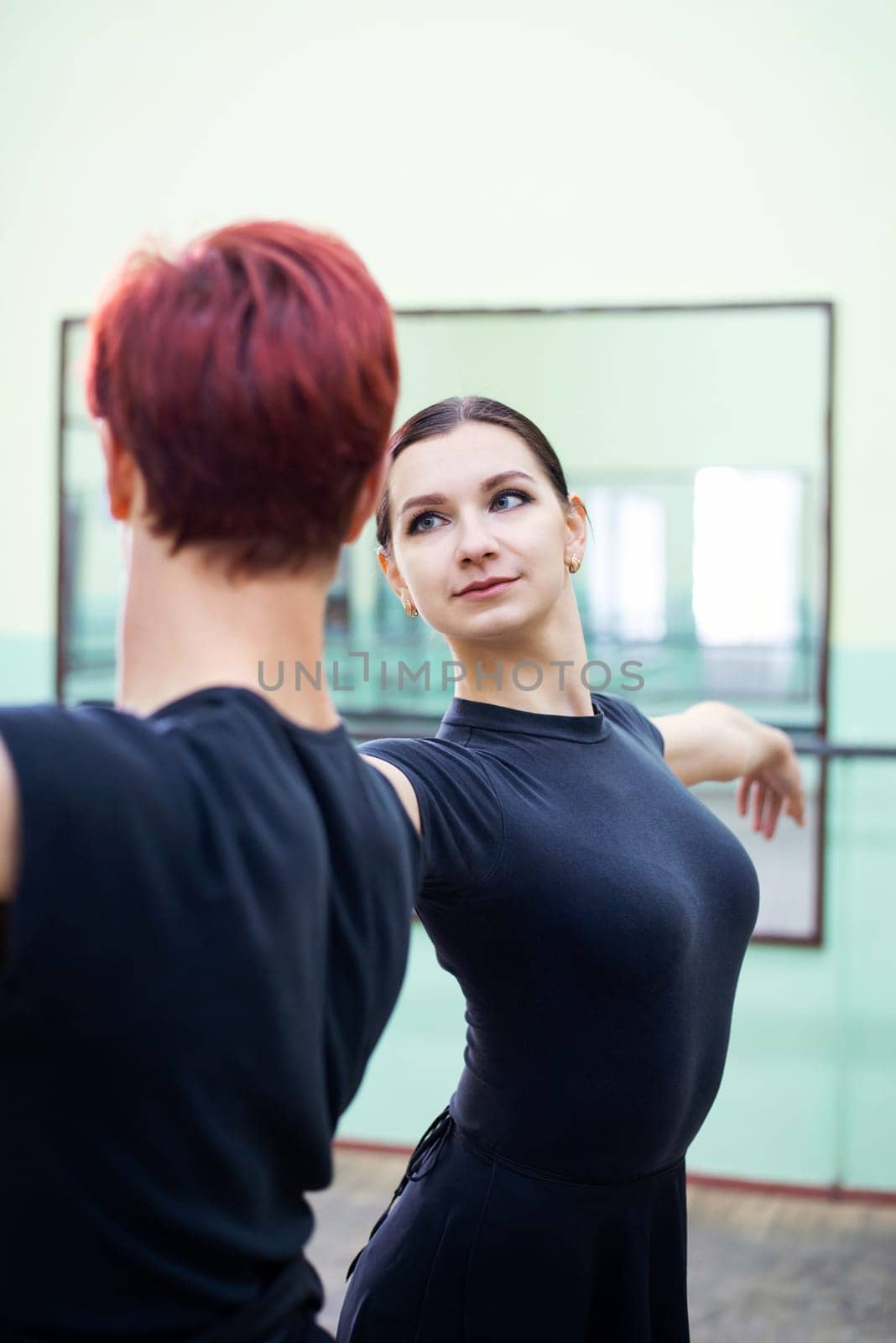 Portrait of pair of young dancers learning new moves of performance together