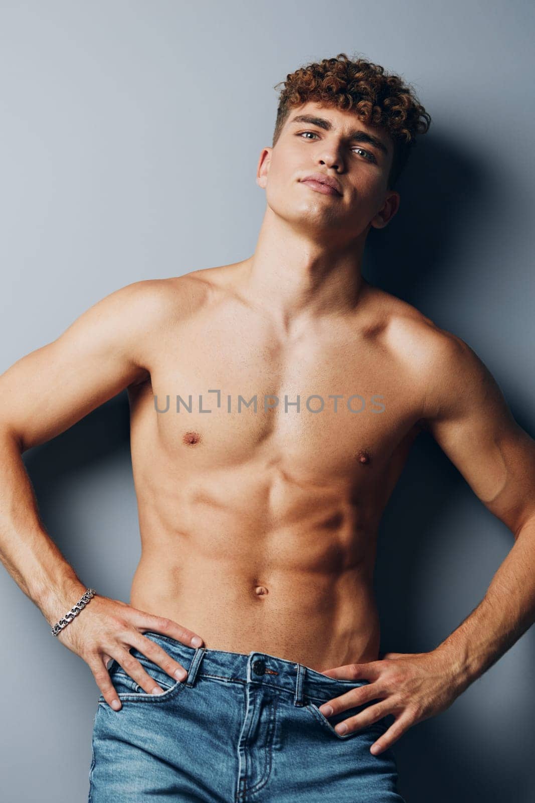 man model muscle bicep background male sport fitness gray background young jeans body studio