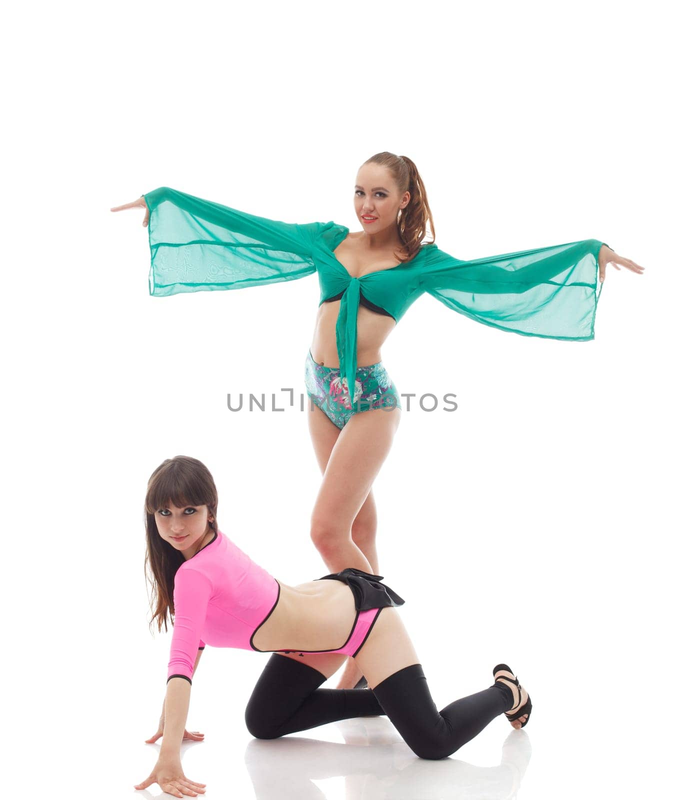 Smiling go-go dancers posing in colorful costumes, isolated on white
