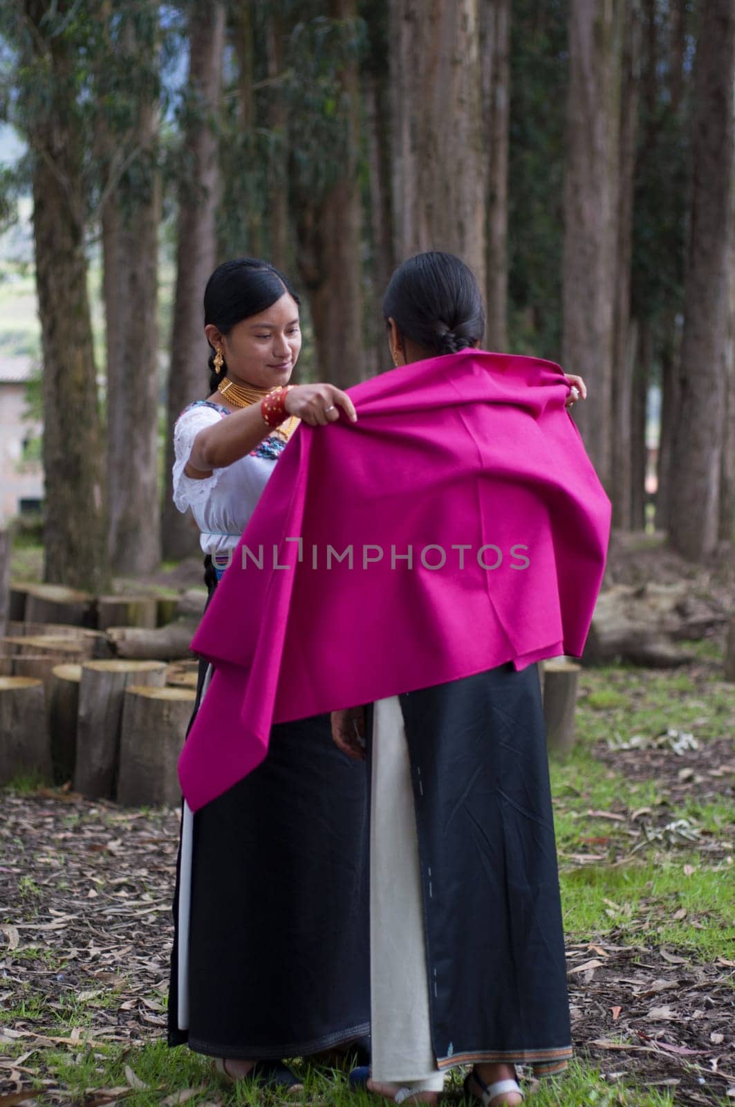 young otavalo native dresses her indigenous friend for a traditional facelift at a wedding by Raulmartin