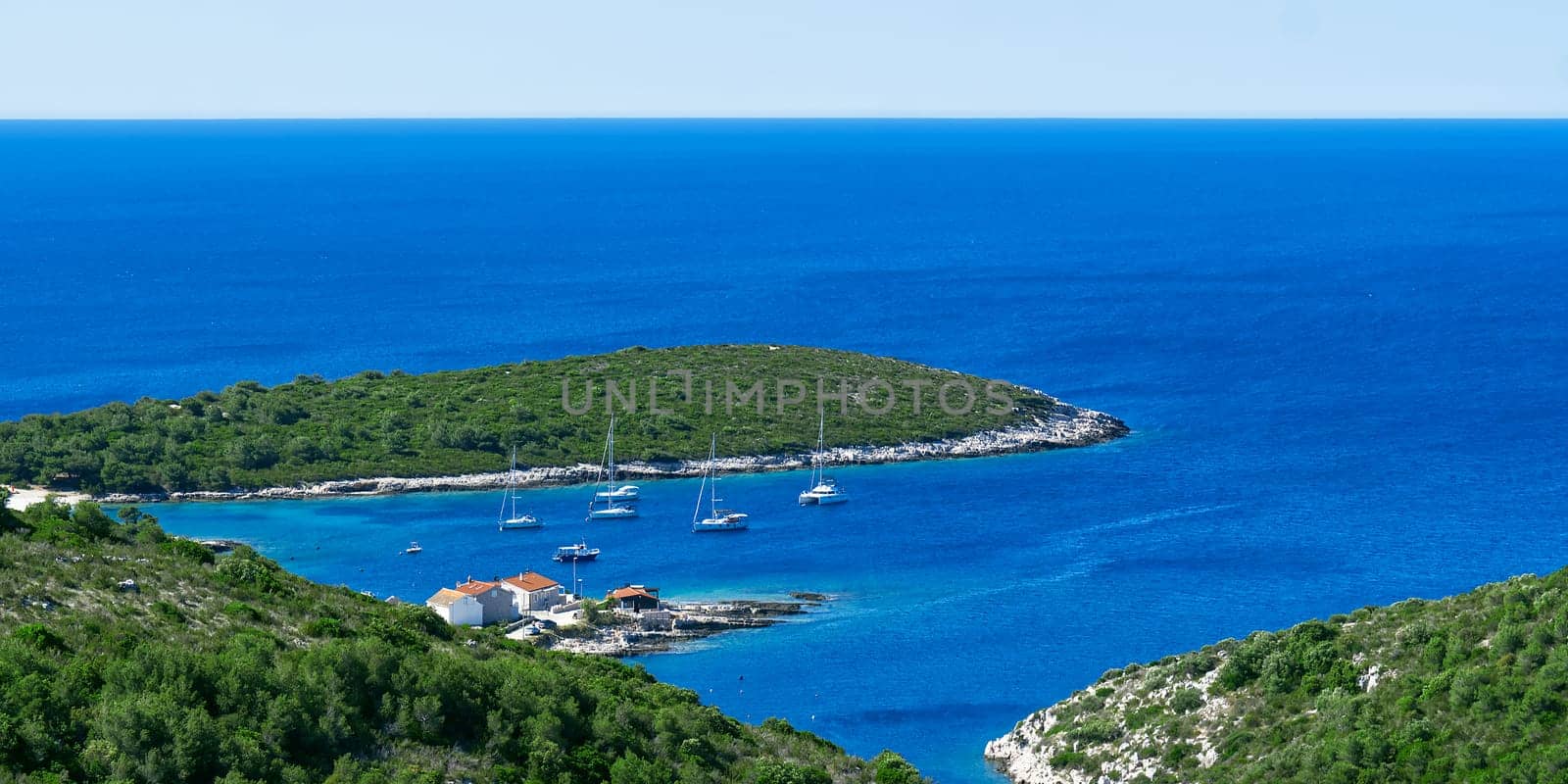 An island in the adriatic sea. Green island in blue adriatic sea , Dalmatia, Croatia by PhotoTime