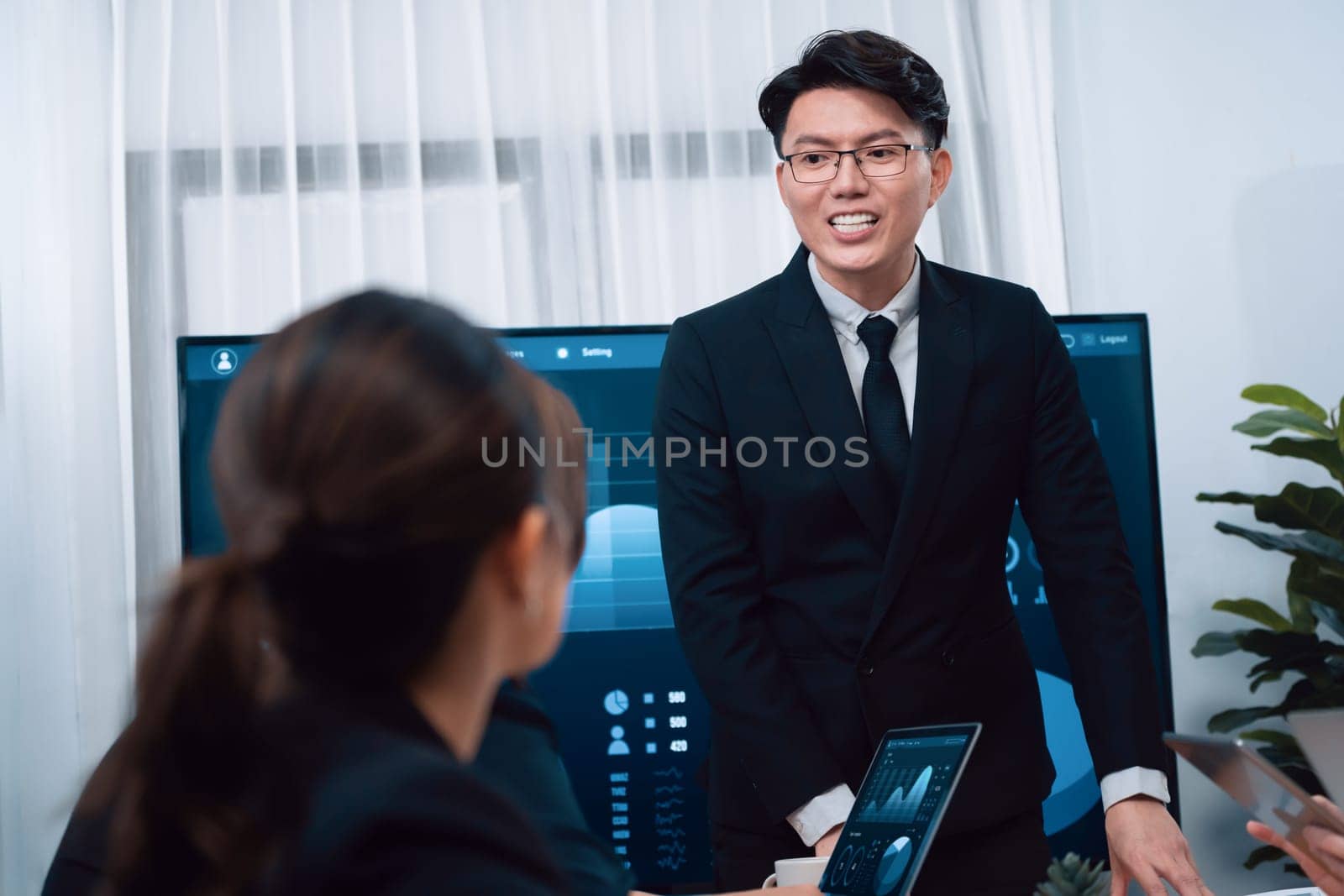 Confidence and asian businessman give presentation on financial analyzed by business intelligence in dashboard report to other people in board room meeting to promote harmony in workplace.