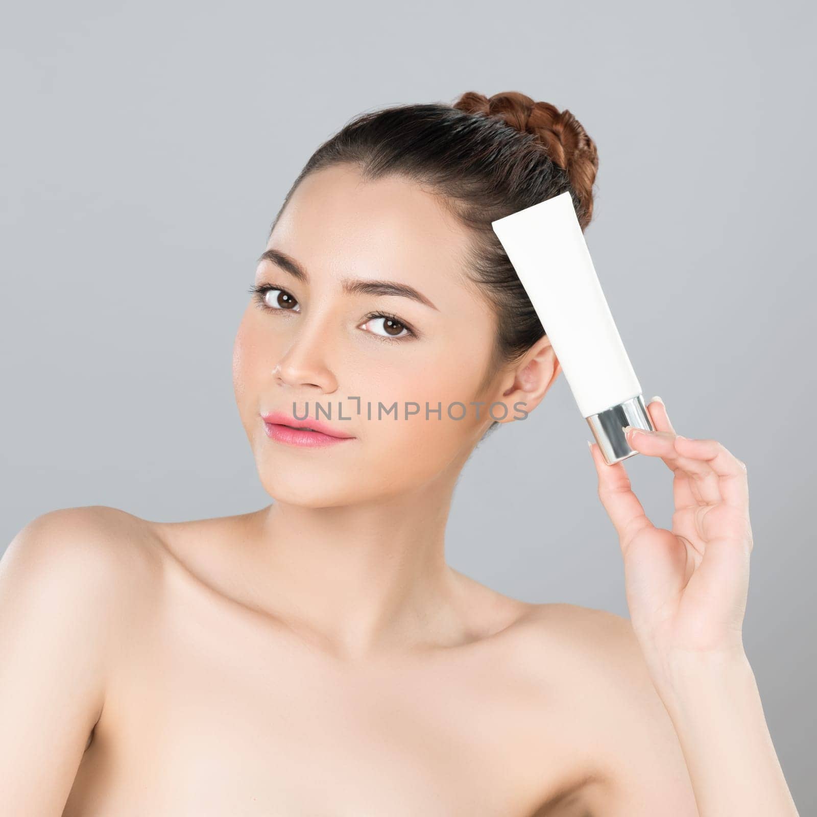 Glamorous perfect skin woman holding mockup moisturizer tube. by biancoblue