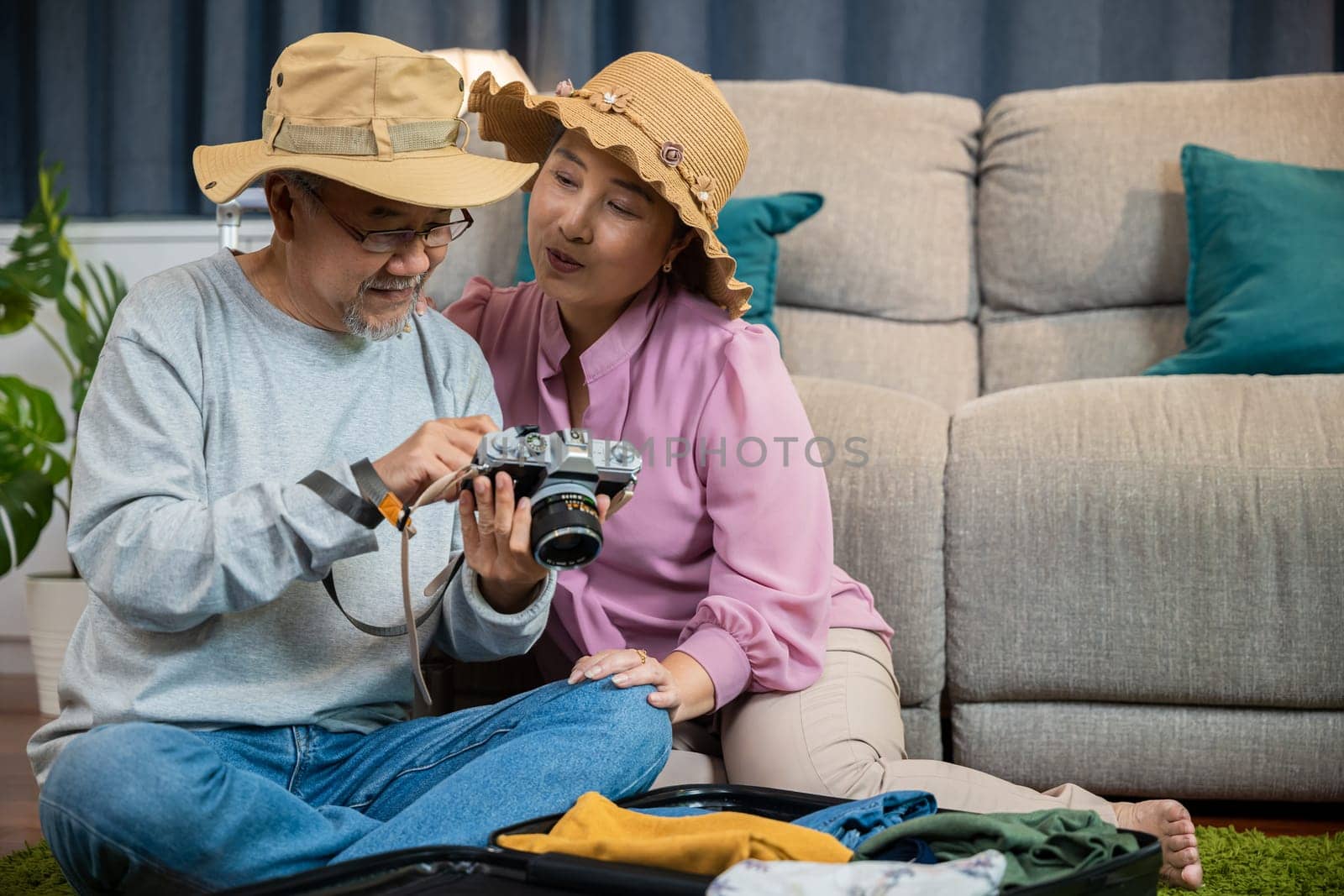 Travel and tourism. Asian couple old senior marry retired couple smiling taking photo by camera during luggage suitcase arranging for travel, Happy mature retired couple photography weekend holiday