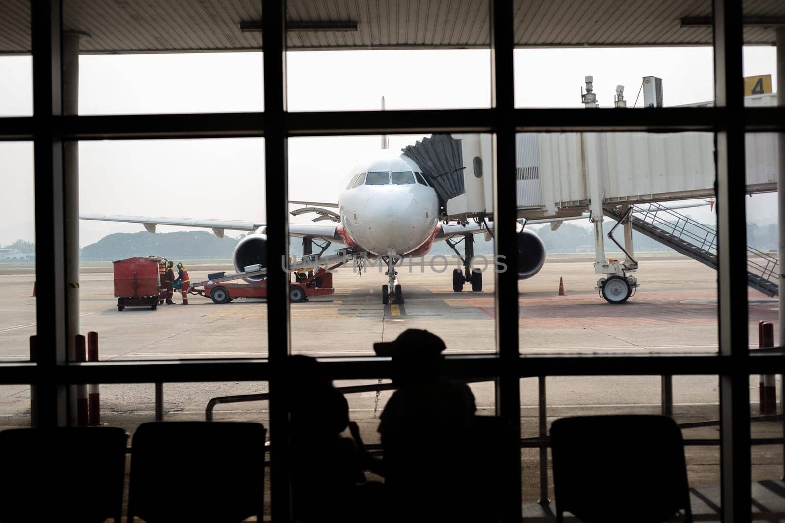 happy family looking at aircraft from terminal, passenger waiting for boarding, . High quality photo