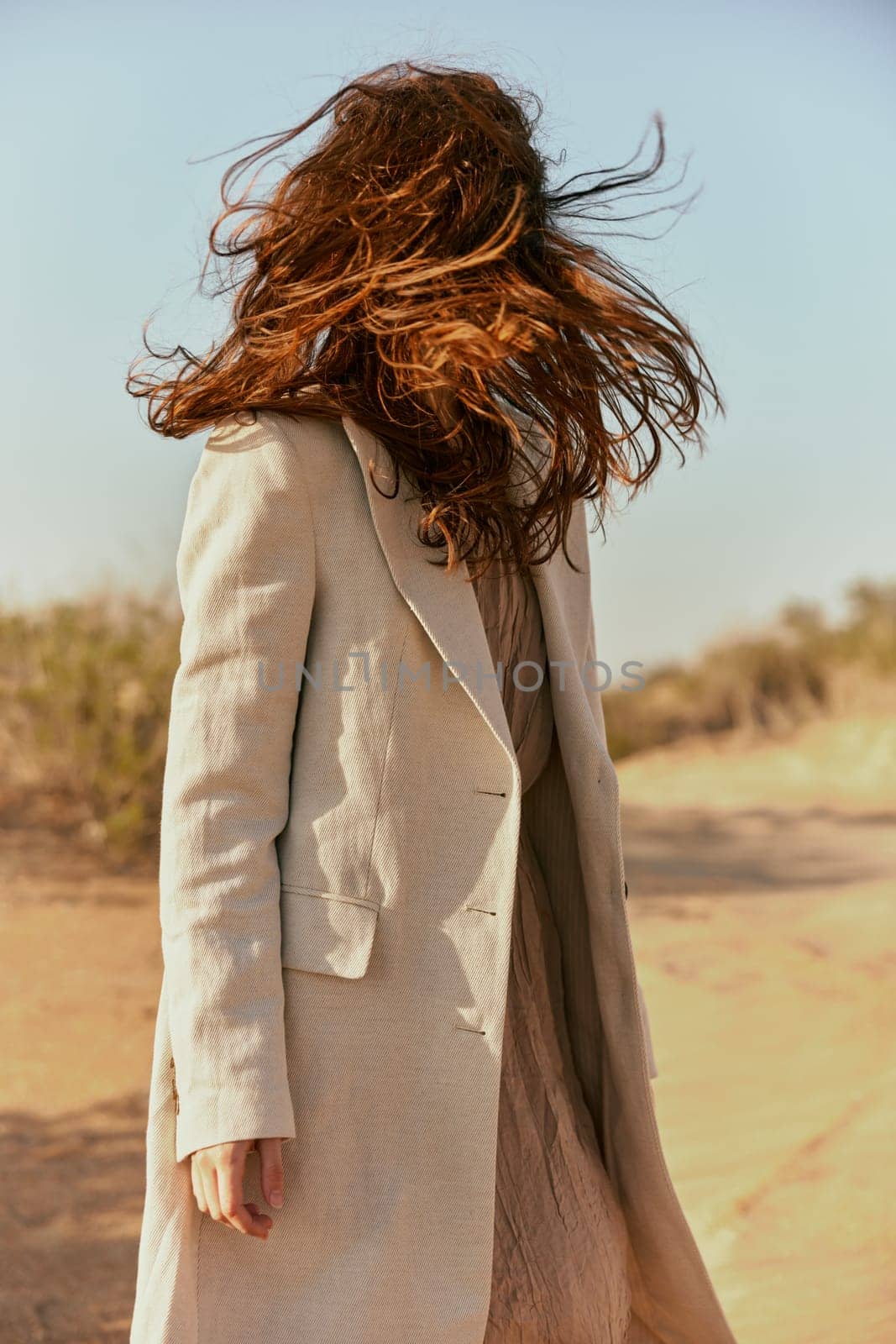a strong wind inflates a woman with red, long hair. High quality photo