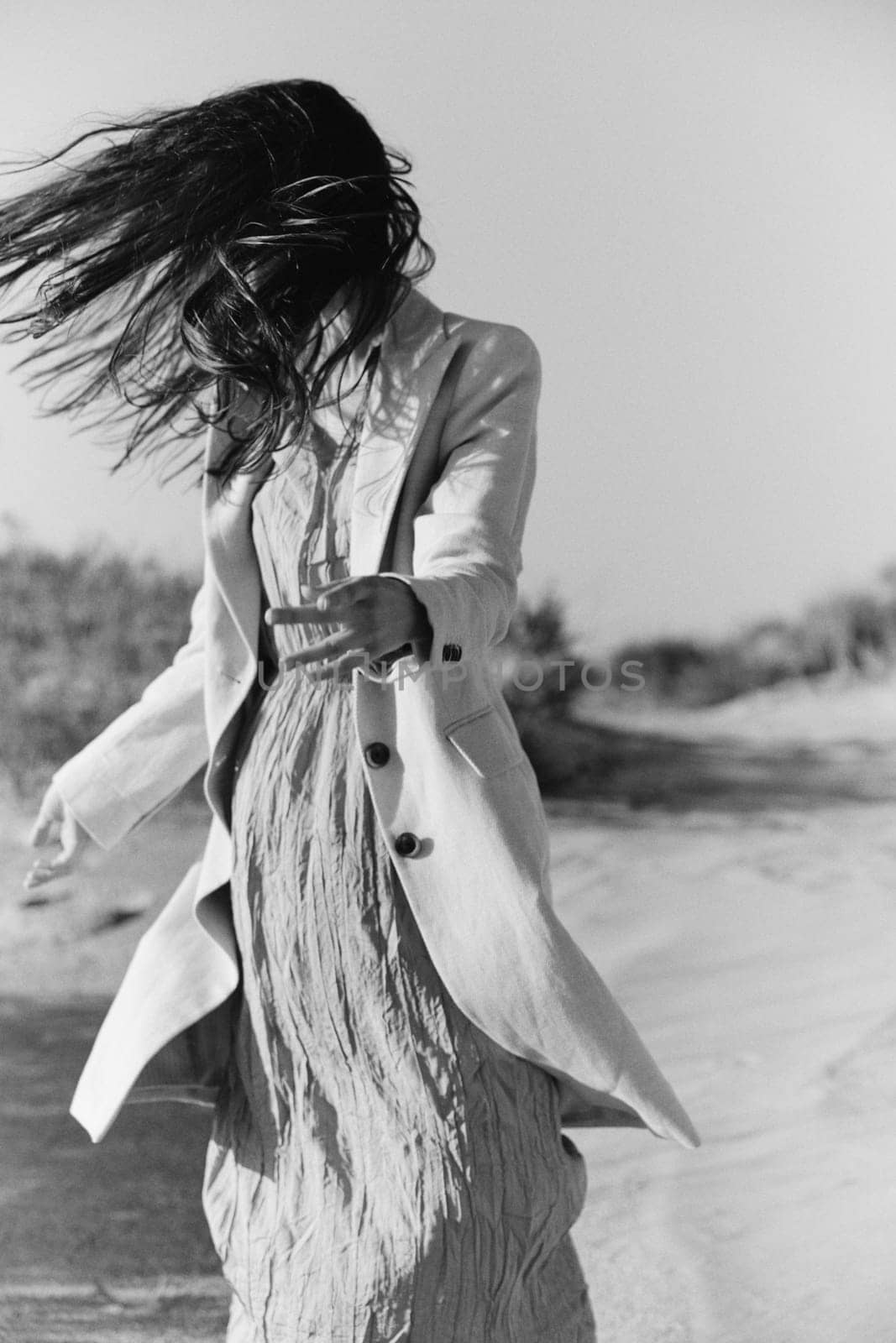 black and white photo of a woman in stylish summer clothes posing in nature. High quality photo