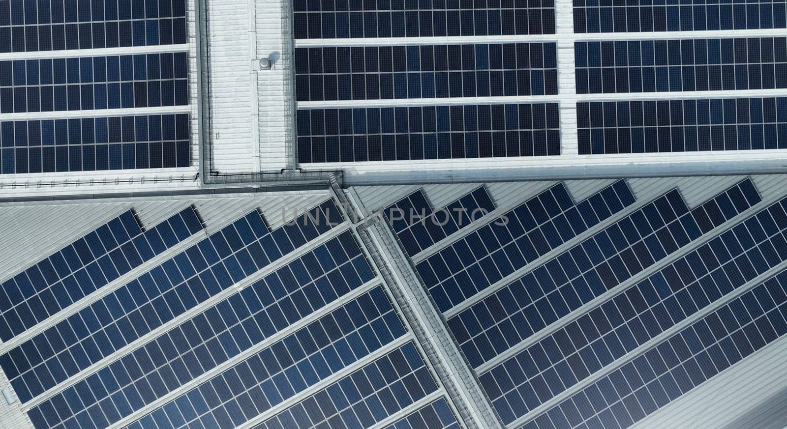 Aerial view of solar panels or photovoltaic module. Solar power for green energy. Sustainable resources. Solar cell panels use sun light as a source to generate electricity. Photovoltaics or PV. by Fahroni