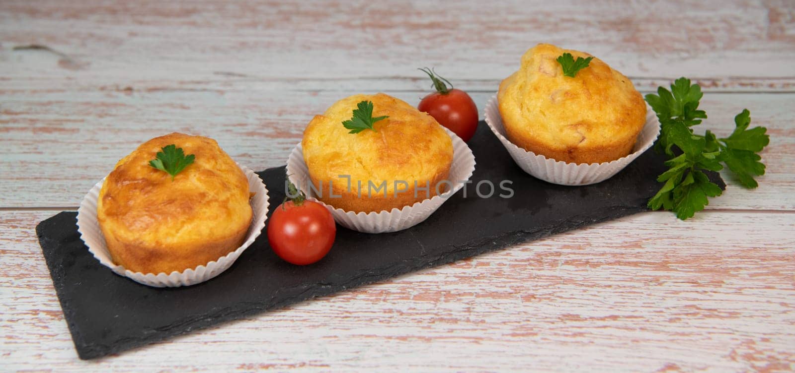 Savory muffin with ham and cheese on blue background by FreeProd