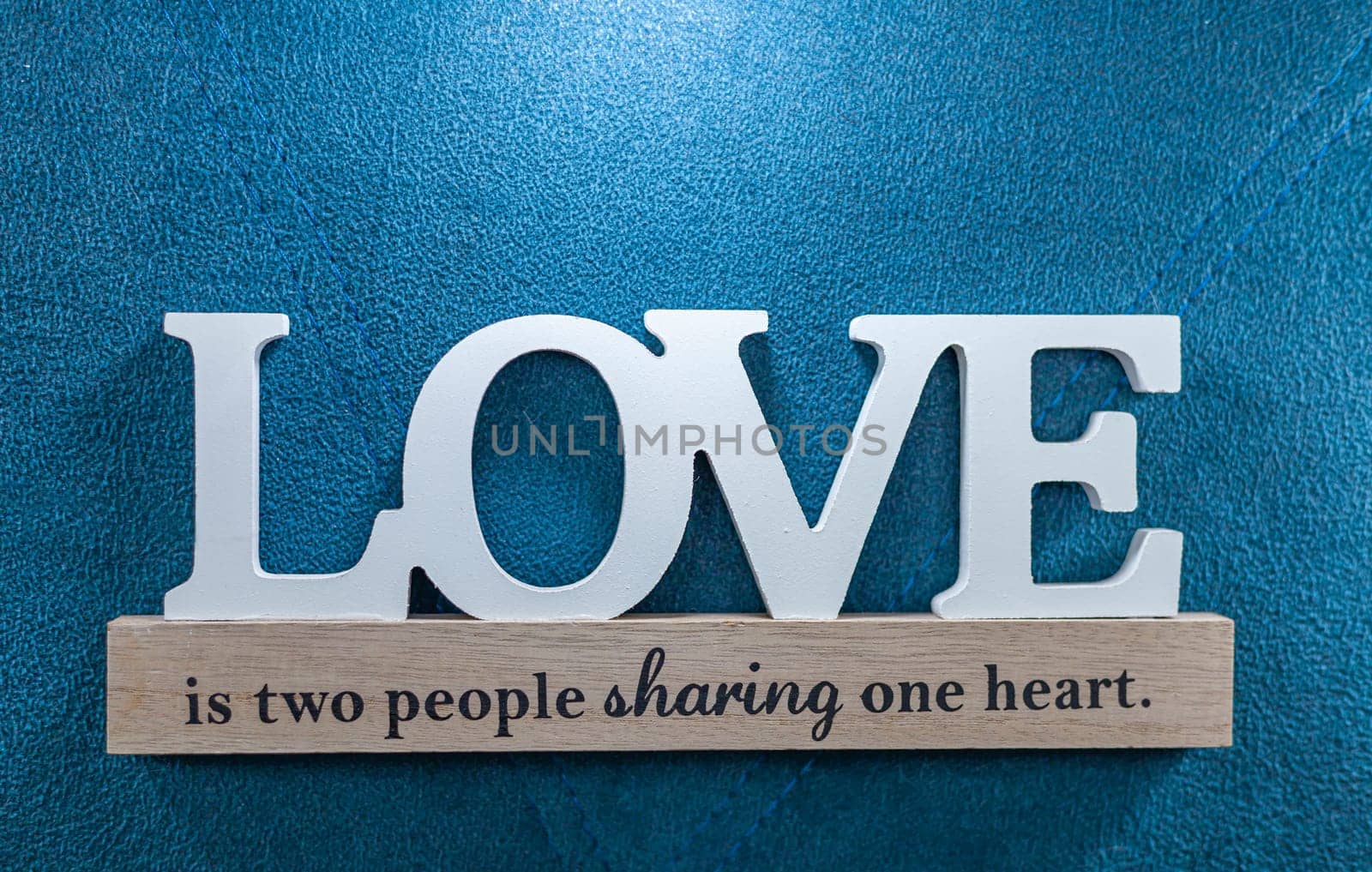 Love wood on the blue backgroud close up