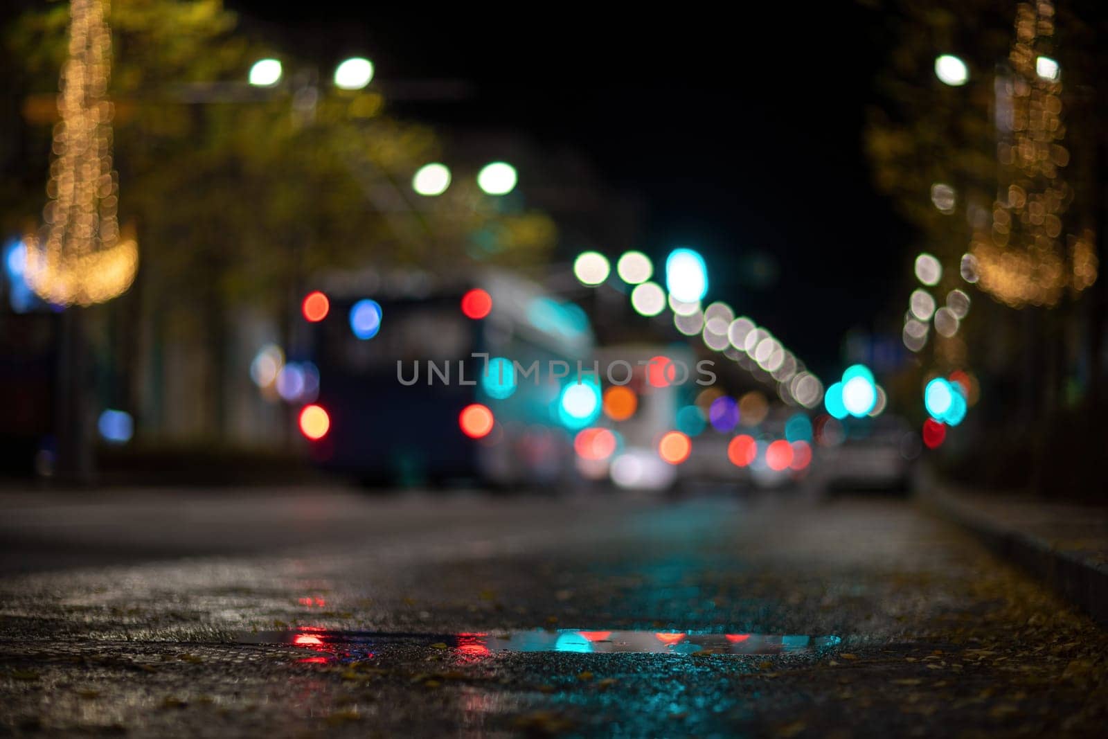 Blurred footage of transport. Blur of city lights along the road, light out of focus at night. Night city traffic, beautiful background