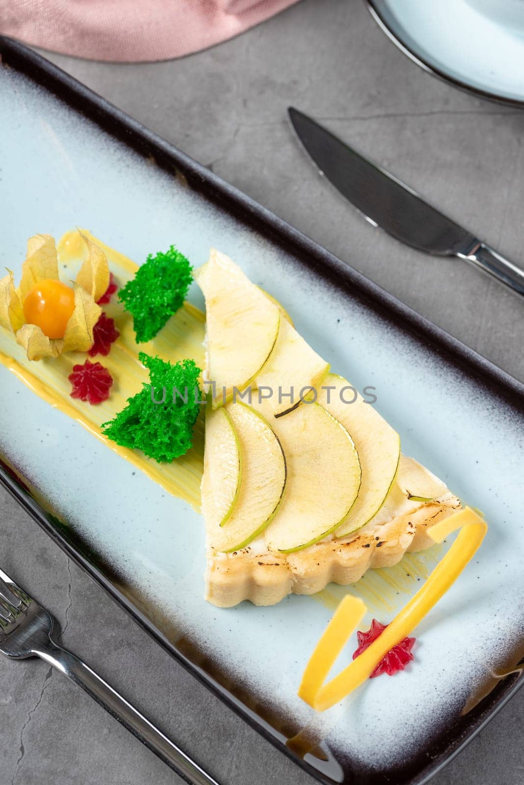 Apple tart on stone table in fine dining restaurant by Sonat