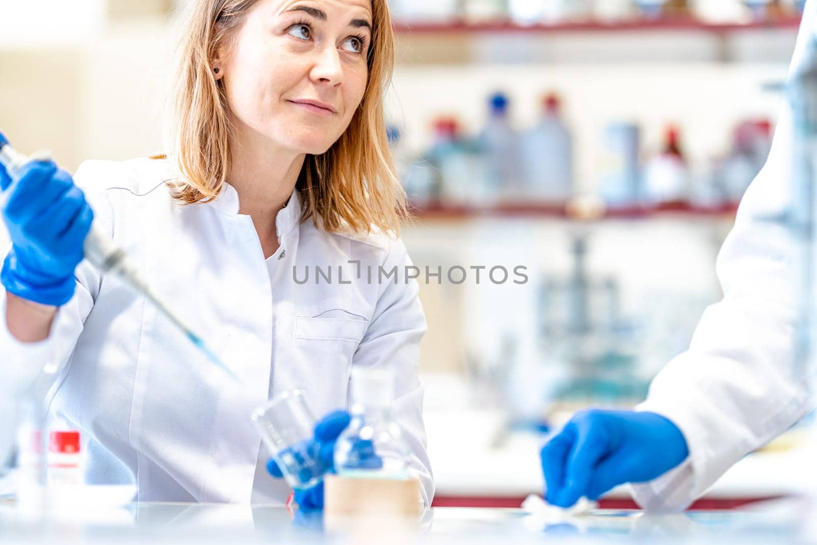 young female scientist is testing a new medicine for the medical industry in a research laboratory by Edophoto