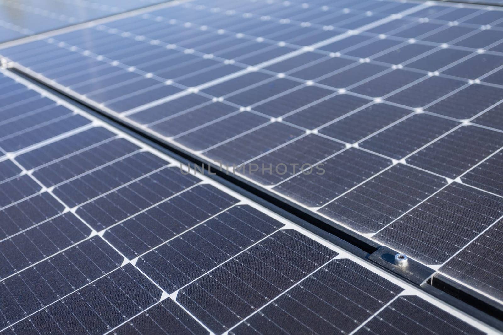 A close-up view of a sheet of several photovoltaic panels stacked one next to the other, ready to be mounted and extracting clean energy from the sun's rays.