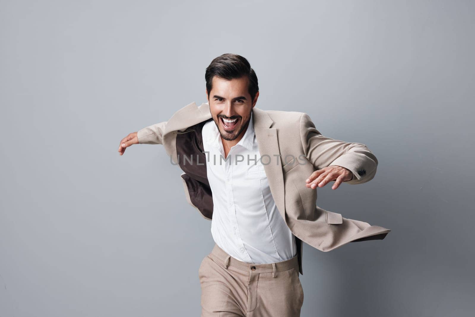 smile man young stylish hand suit business portrait fashion professional running white success happy beige adult winner up victory businessman tie