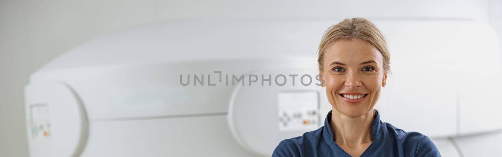 Portrait of doctor radiologist on background of MRI or CT Scan with patient undergoing procedure by Yaroslav_astakhov