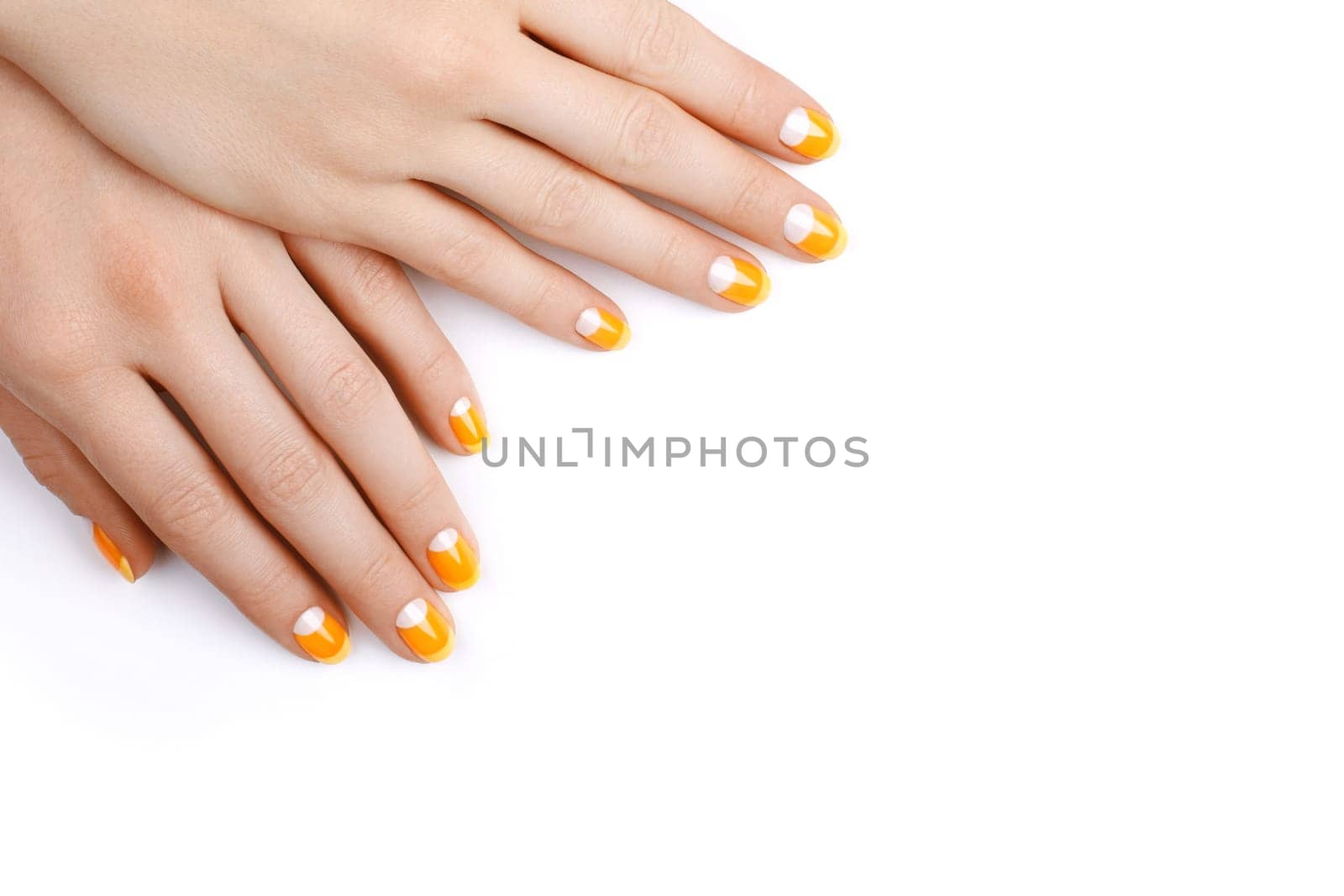 Beautiful Female Hands with bright orange Manicure like Candy Corn. Manicured Nails with Yellow Gel Polish. Halloween Style by MarinaFrost