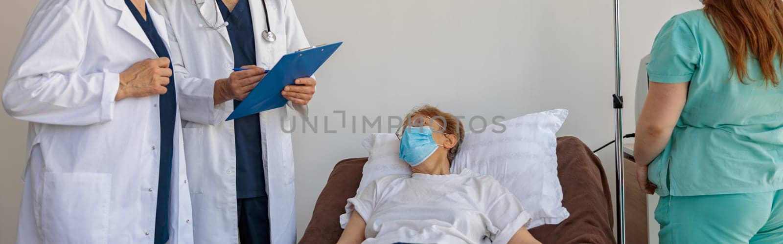 Professional doctors discuss over patient's diagnosis standing in hospital ward. High quality photo