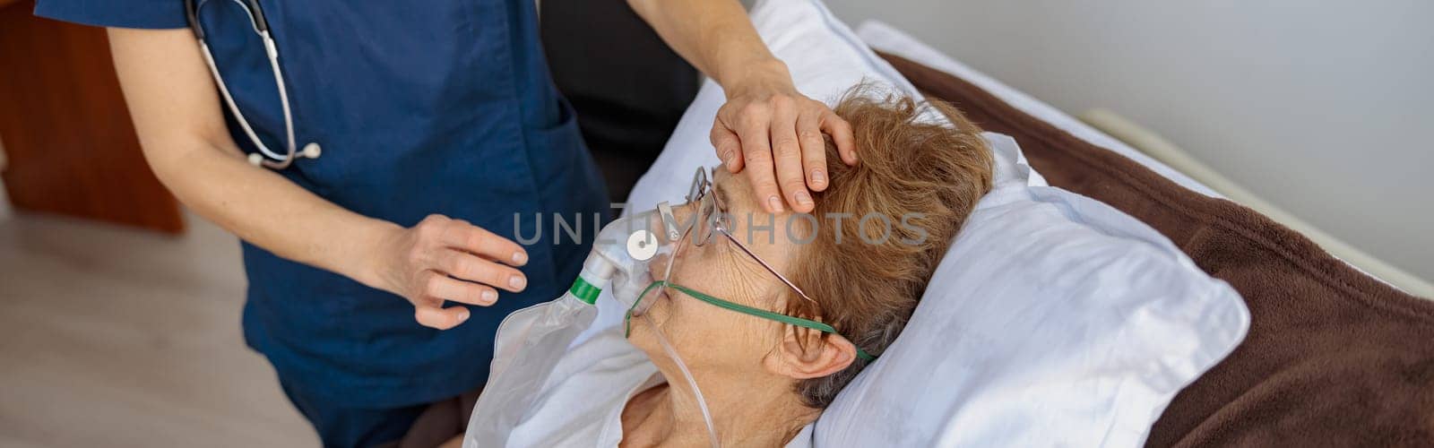 Doctor putting on a breathing mask on a female patient with covid-19. High quality photo