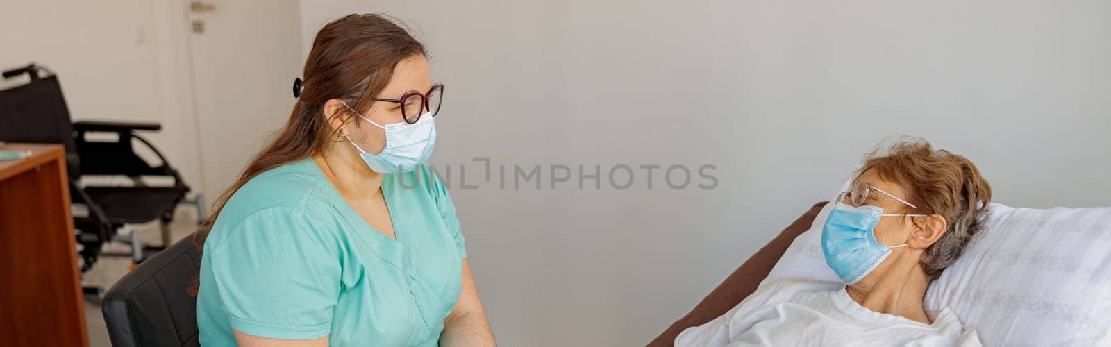 Professional Nurse controls drip of her patient in modern medicine clinic. High quality photo