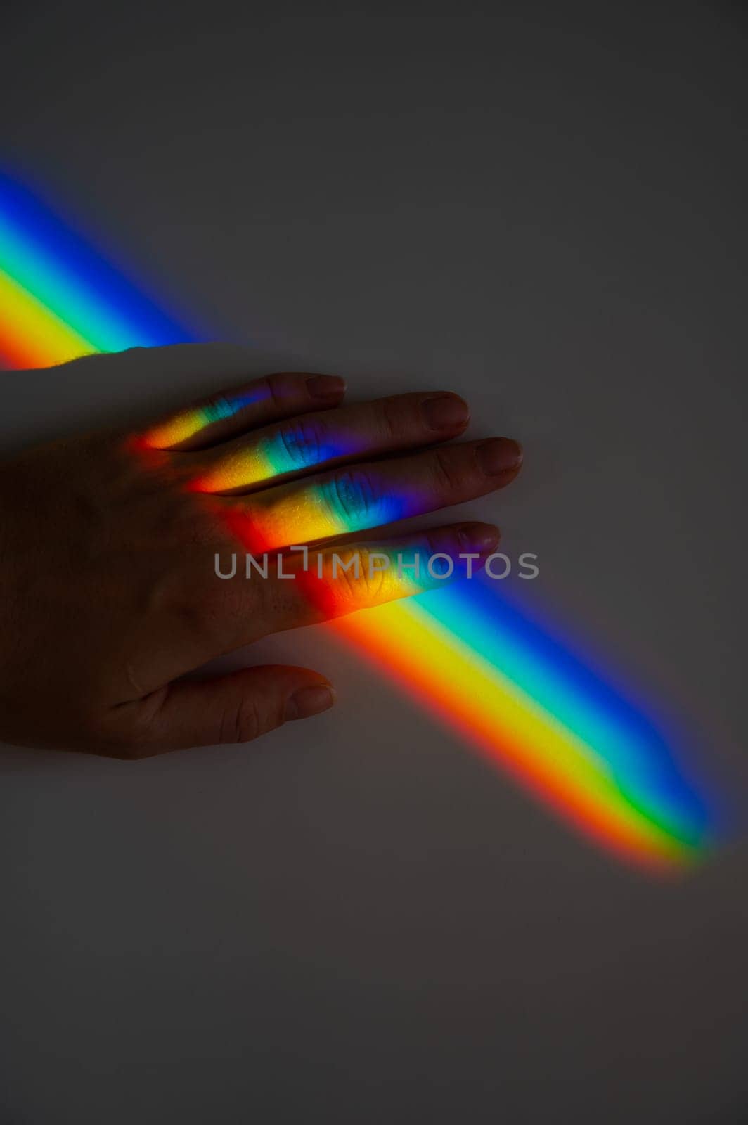 Rainbow ray on a woman's hand. by mrwed54
