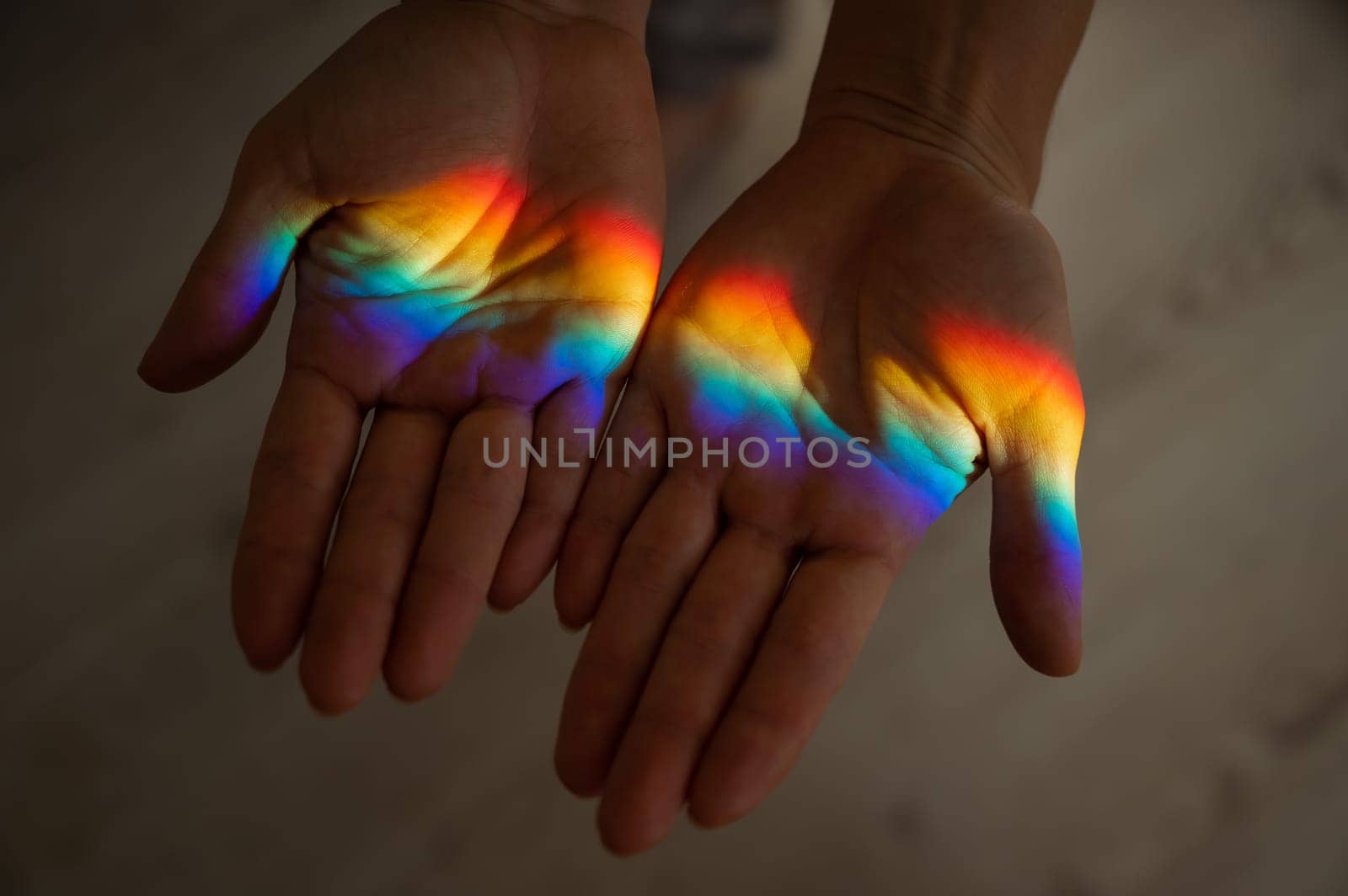 Rainbow ray on a woman's hand. by mrwed54