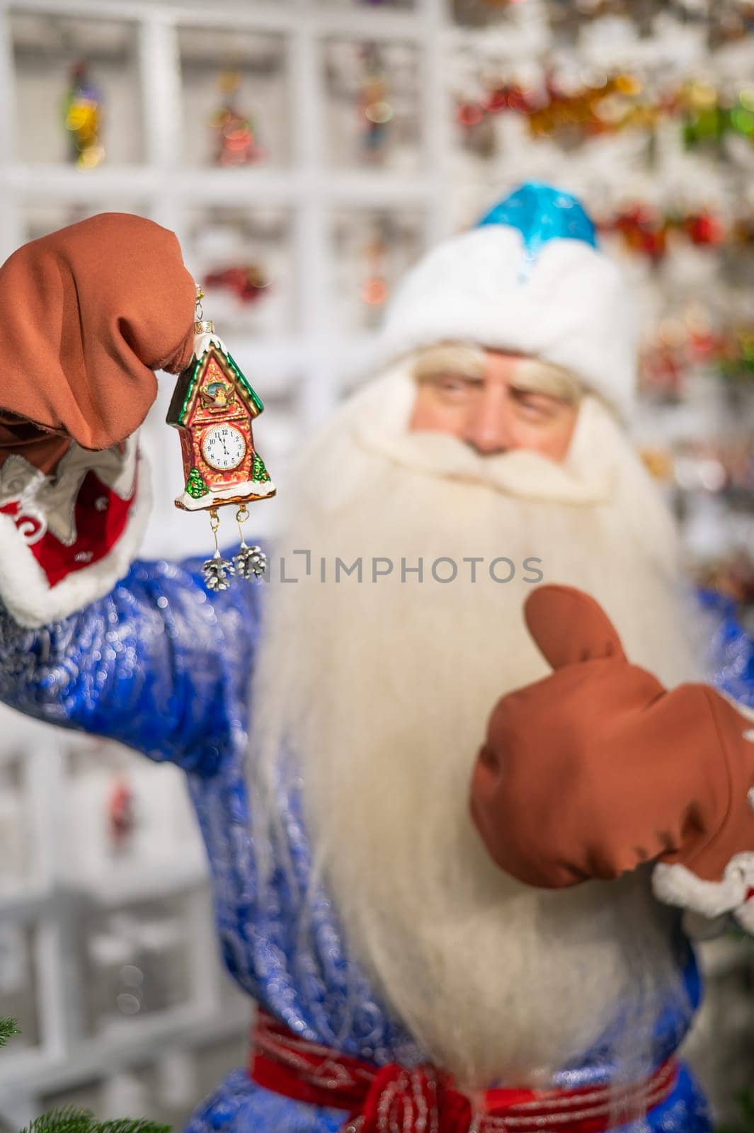 Russian Santa Claus chooses decorations for the Christmas tree in the store. by mrwed54