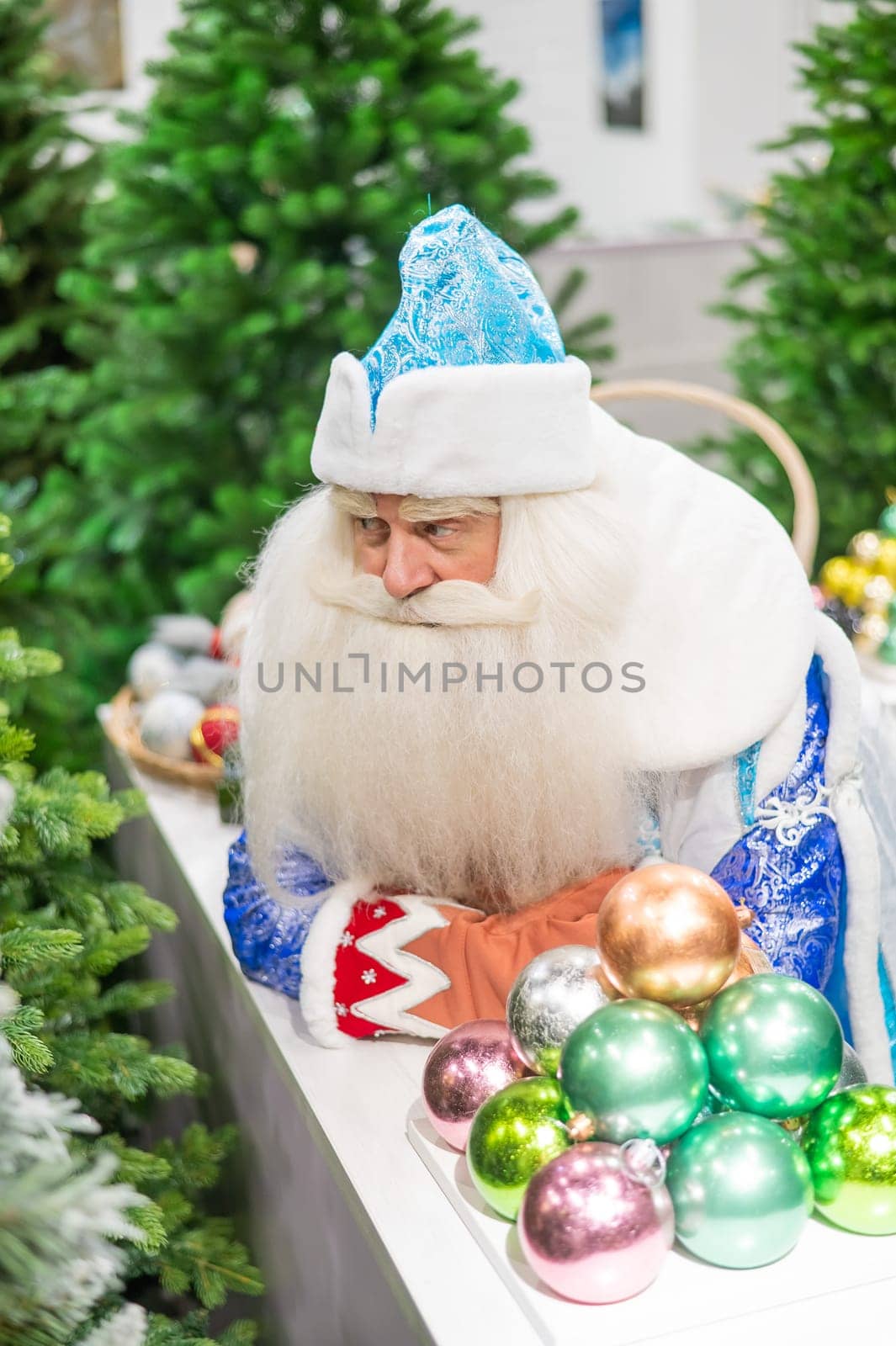 Russian santa claus holds decorations for the christmas tree in the store. by mrwed54