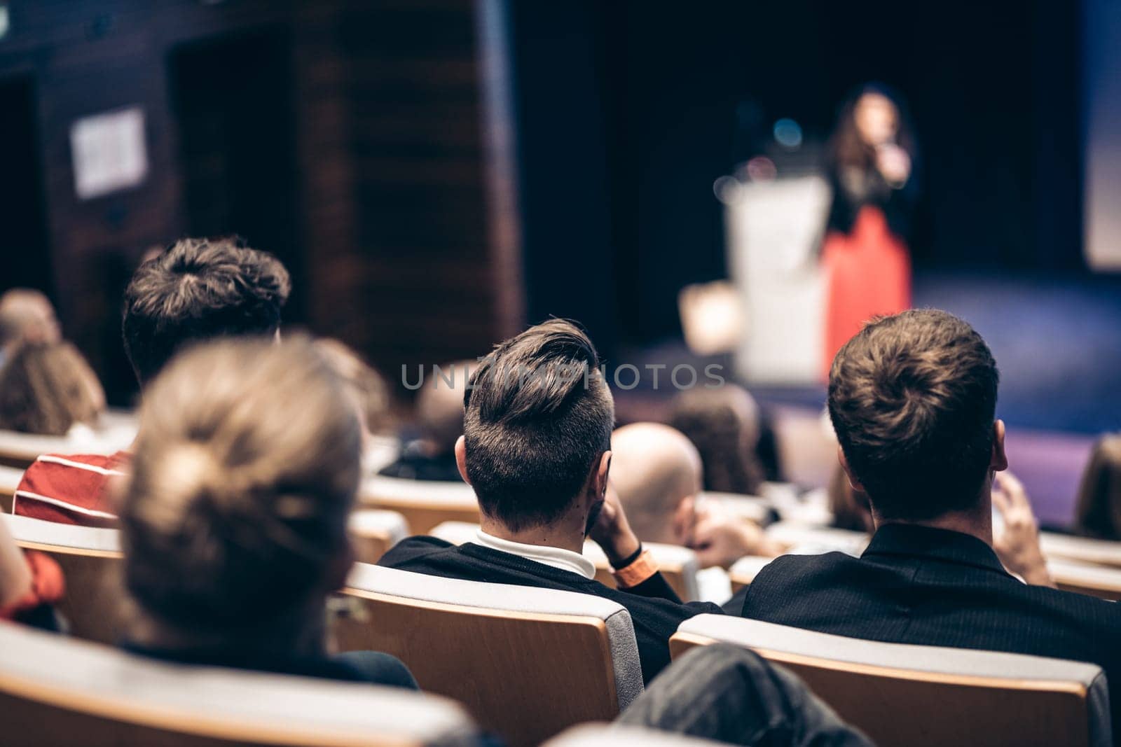 Woman giving presentation on business conference event. by kasto