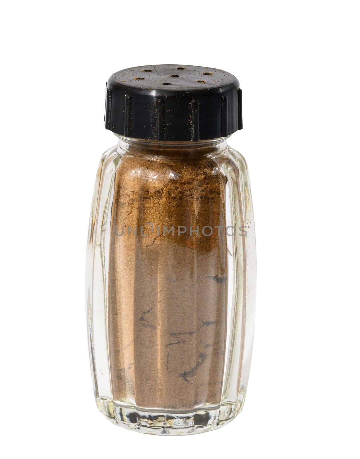 Transparent glass jar with ground cinnamon on a white isolated background, spice by ndanko