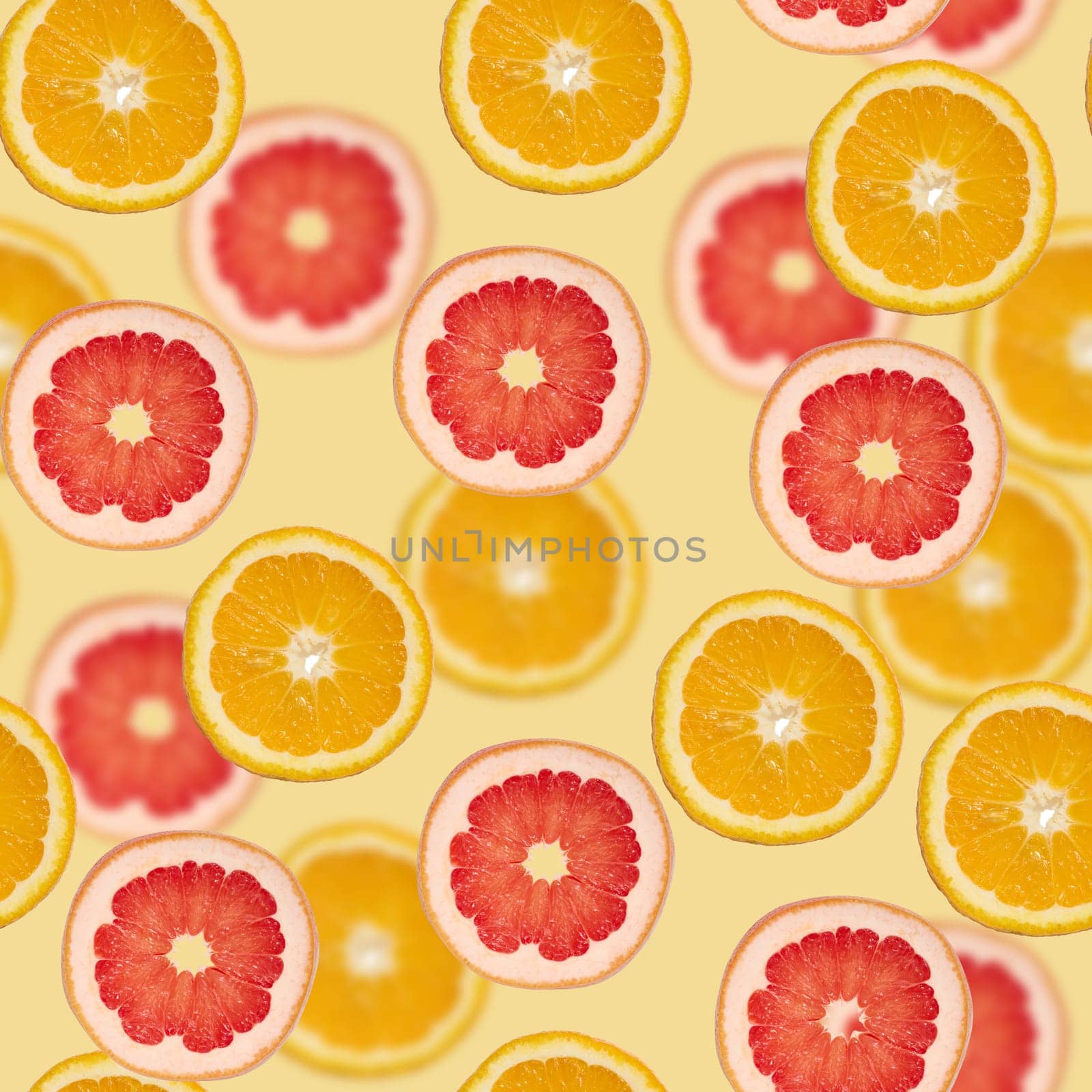 Sliced pieces of orange, lime and grapefruit on a green background. Seamless pattern by ndanko