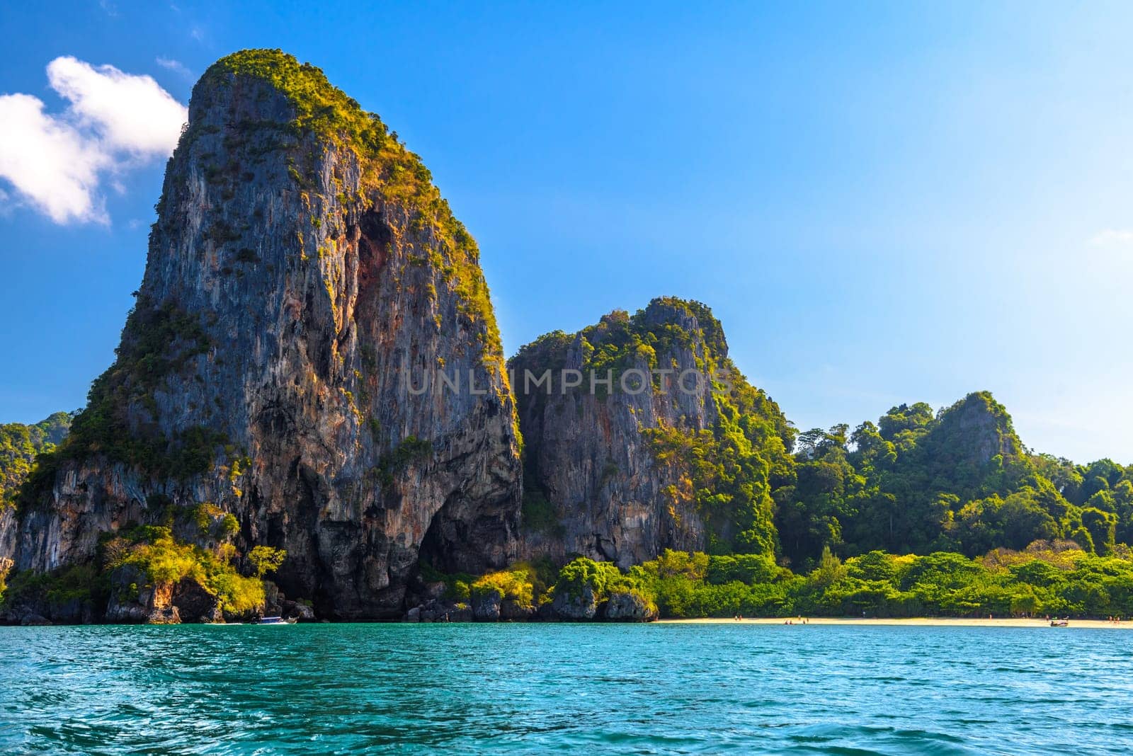 Huge cliff rocks in azure water, Railay beach, Ao Nang, Krabi, Thailand.