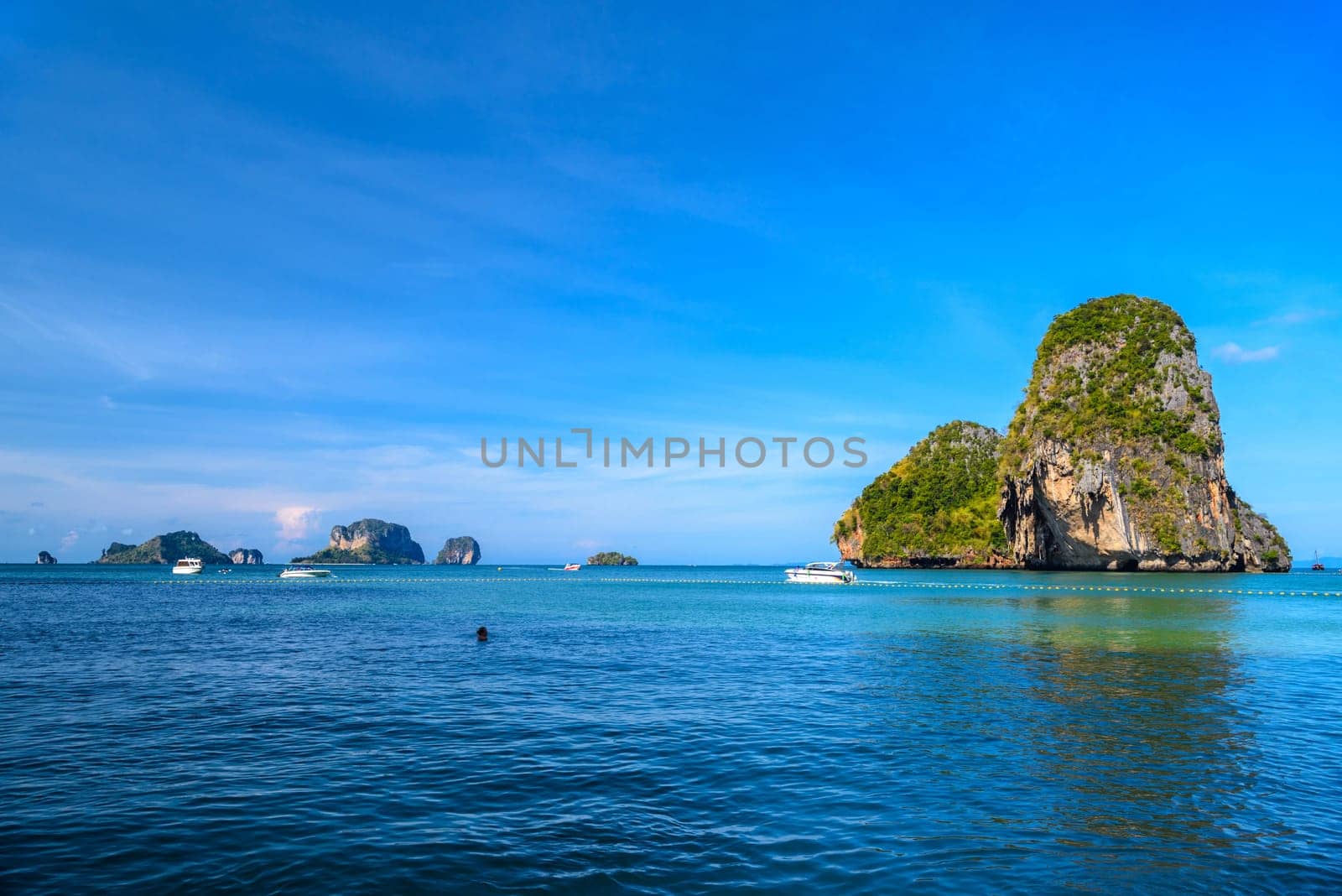 Huge cliff rock in azure water, Ko Rang Nok, Ao Phra Nang Beach, Ao Nang, Krabi, Thailand.