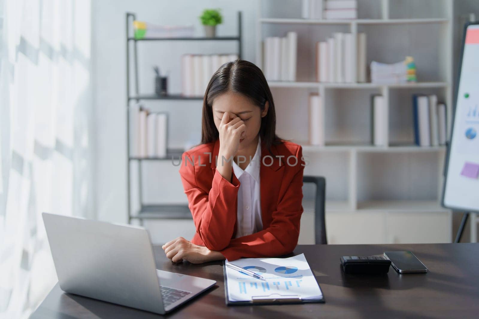 Portrait of business owner, woman using computer and financial statements Anxious expression on expanding the market to increase the ability to invest in business.