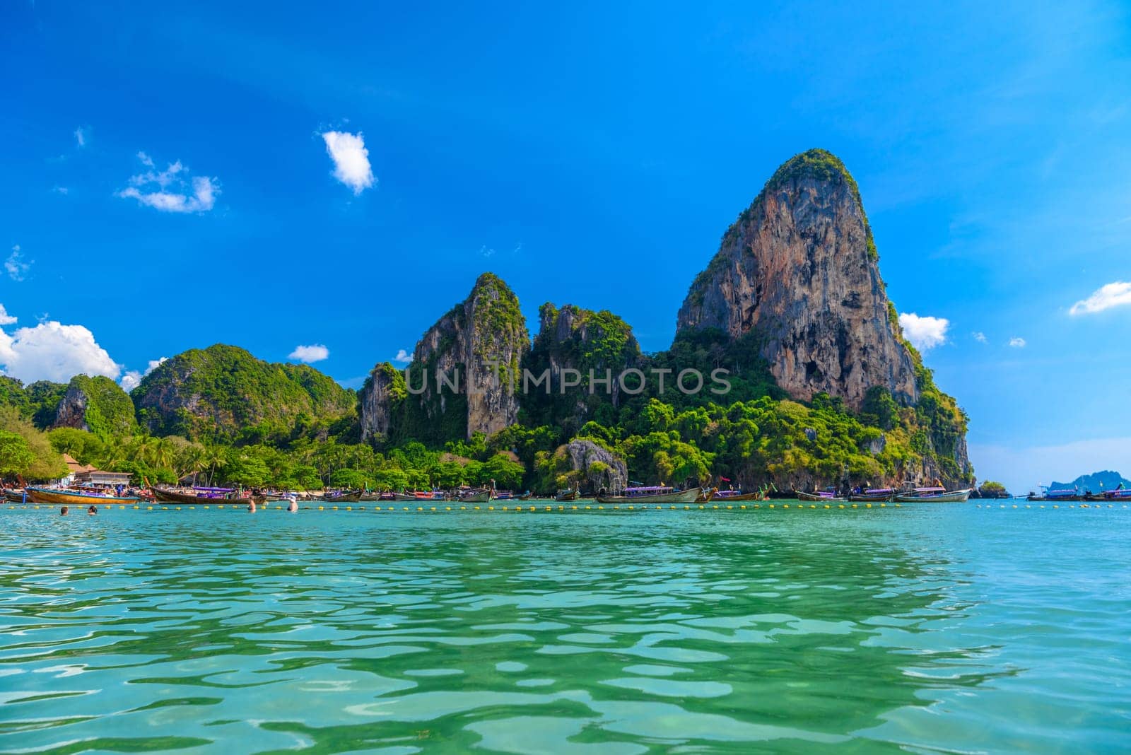 Rocks and cliffs, water and tropical white sand beach, Railay beach west, Ao Nang, Krabi, Thailand.