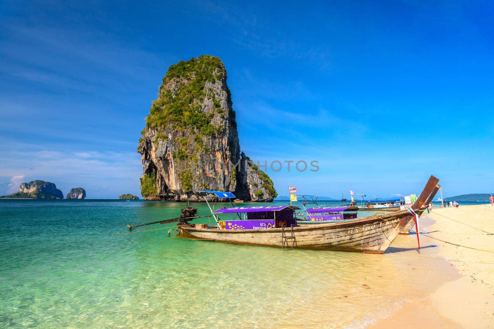 KRABI, THAILAND- MARCH 2018: Long tail boats and cliff rock in azure water, Ko Rang Nok, Ao Phra Nang Beach, Ao Nang, Krabi, Thailand.