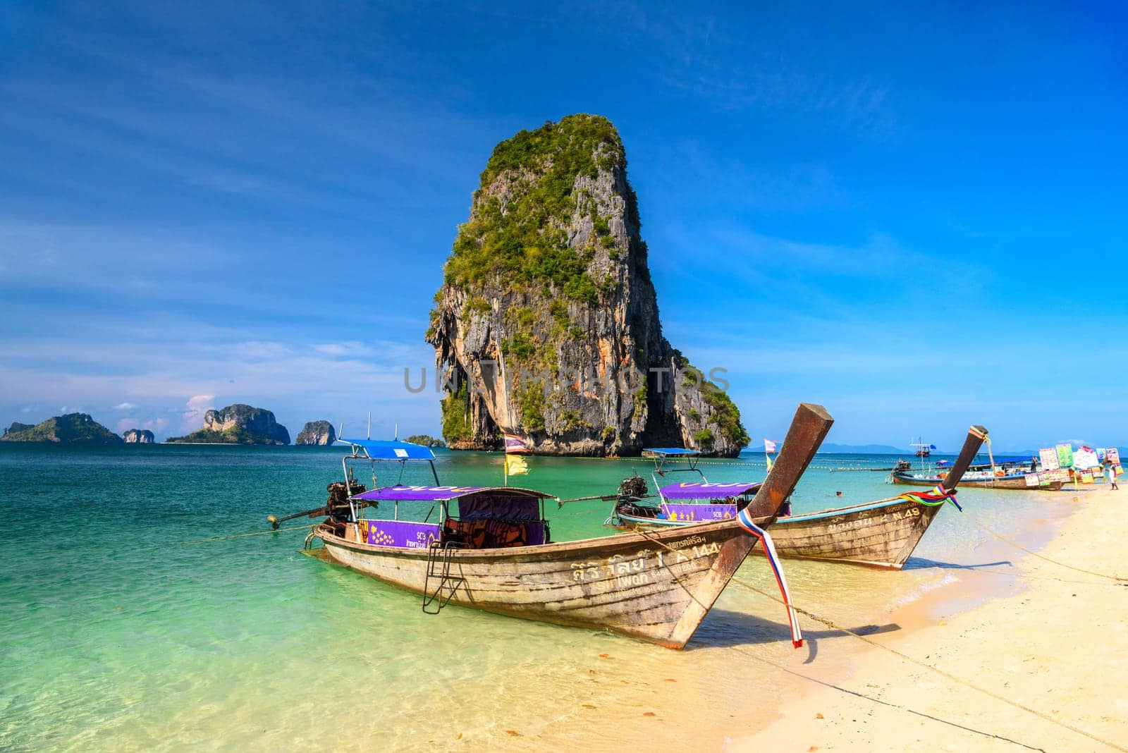 KRABI, THAILAND- MARCH 2018: Long tail boats and cliff rock in azure water, Ko Rang Nok, Ao Phra Nang Beach, Ao Nang, Krabi, Thailand.