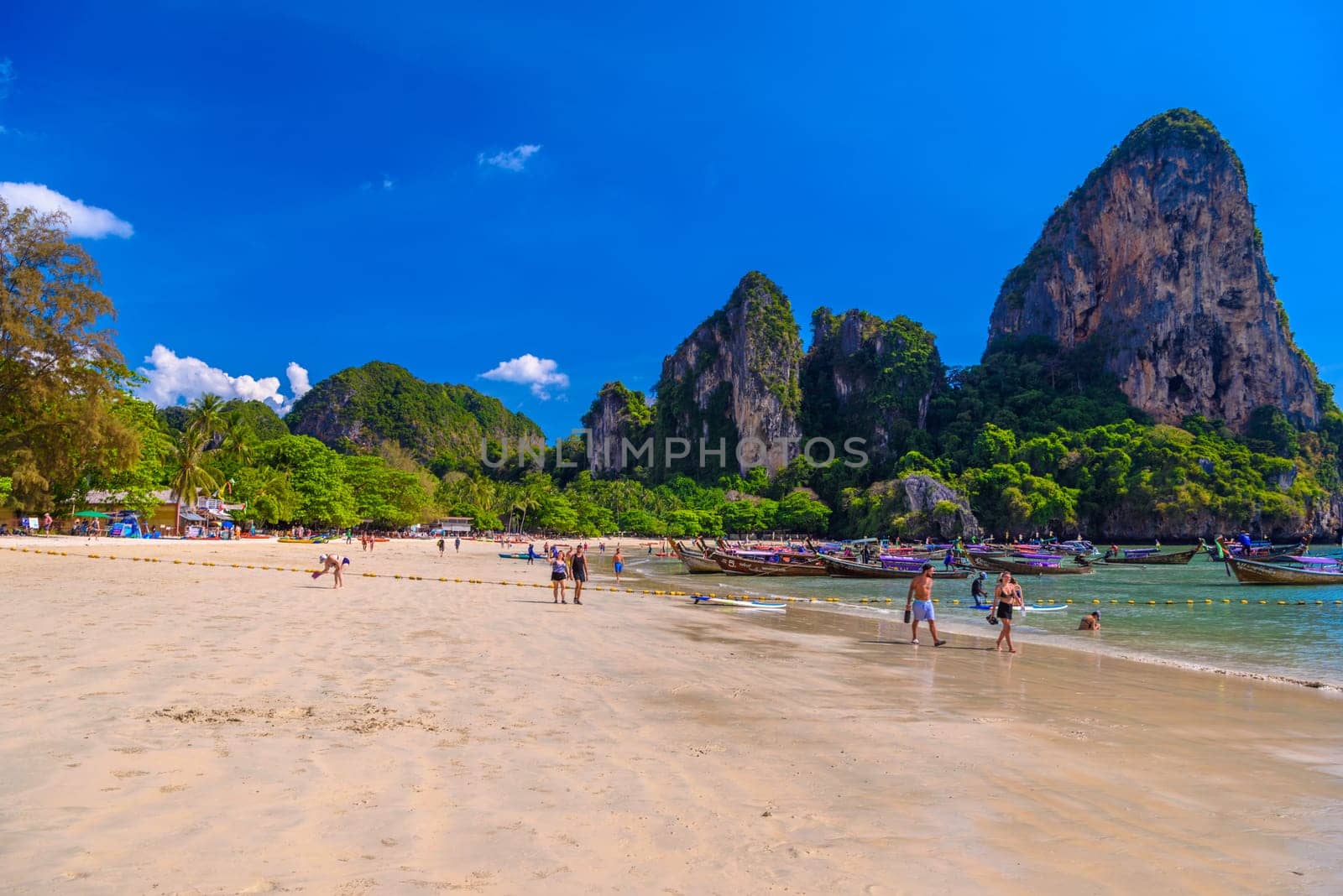 KRABI, THAILAND- MARCH 2018: Rocks, water and tropical white sand beach, Railay beach west, Ao Nang, Krabi, Thailand by Eagle2308